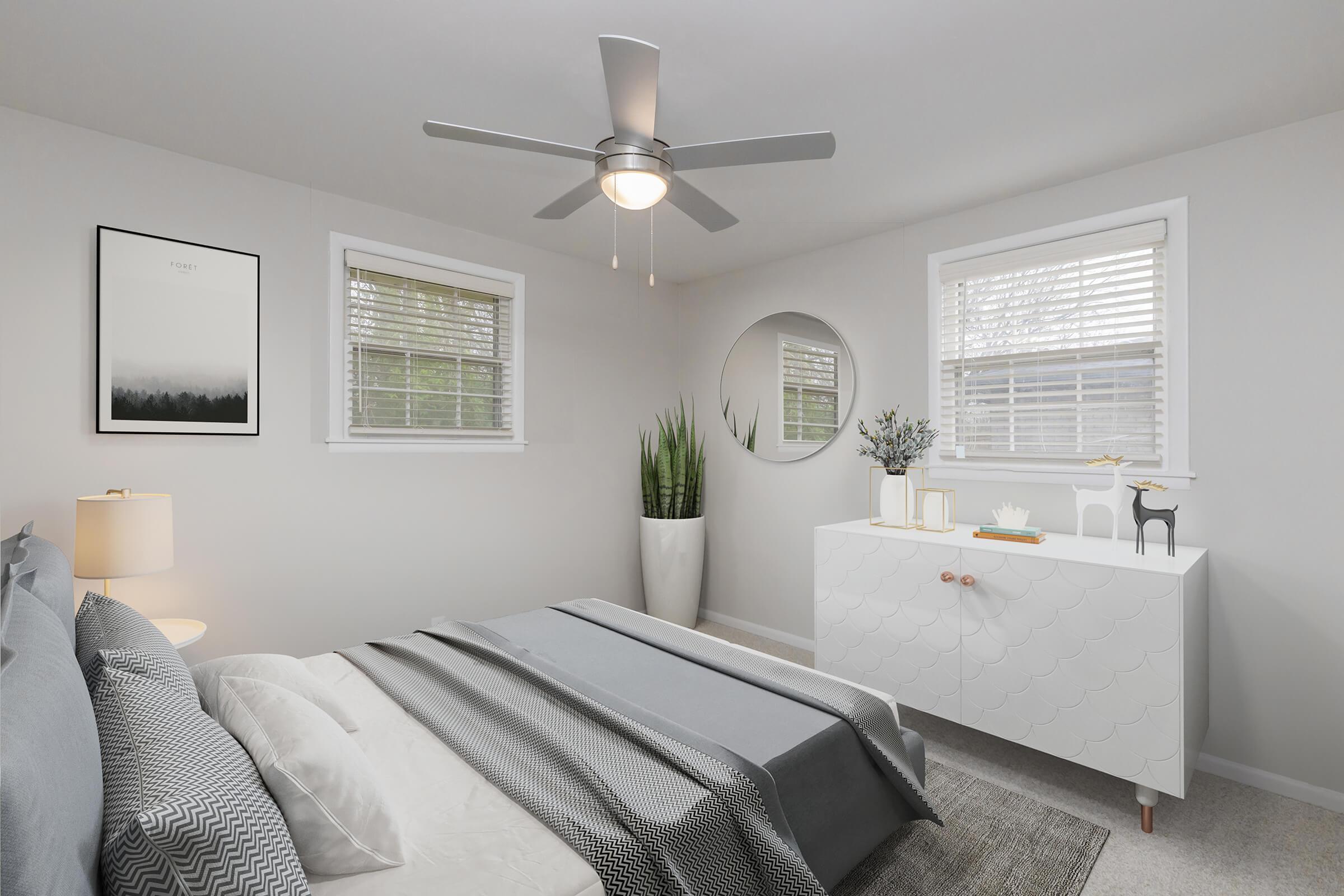 Cozy bedroom with a ceiling fan in Hermitage, TN.