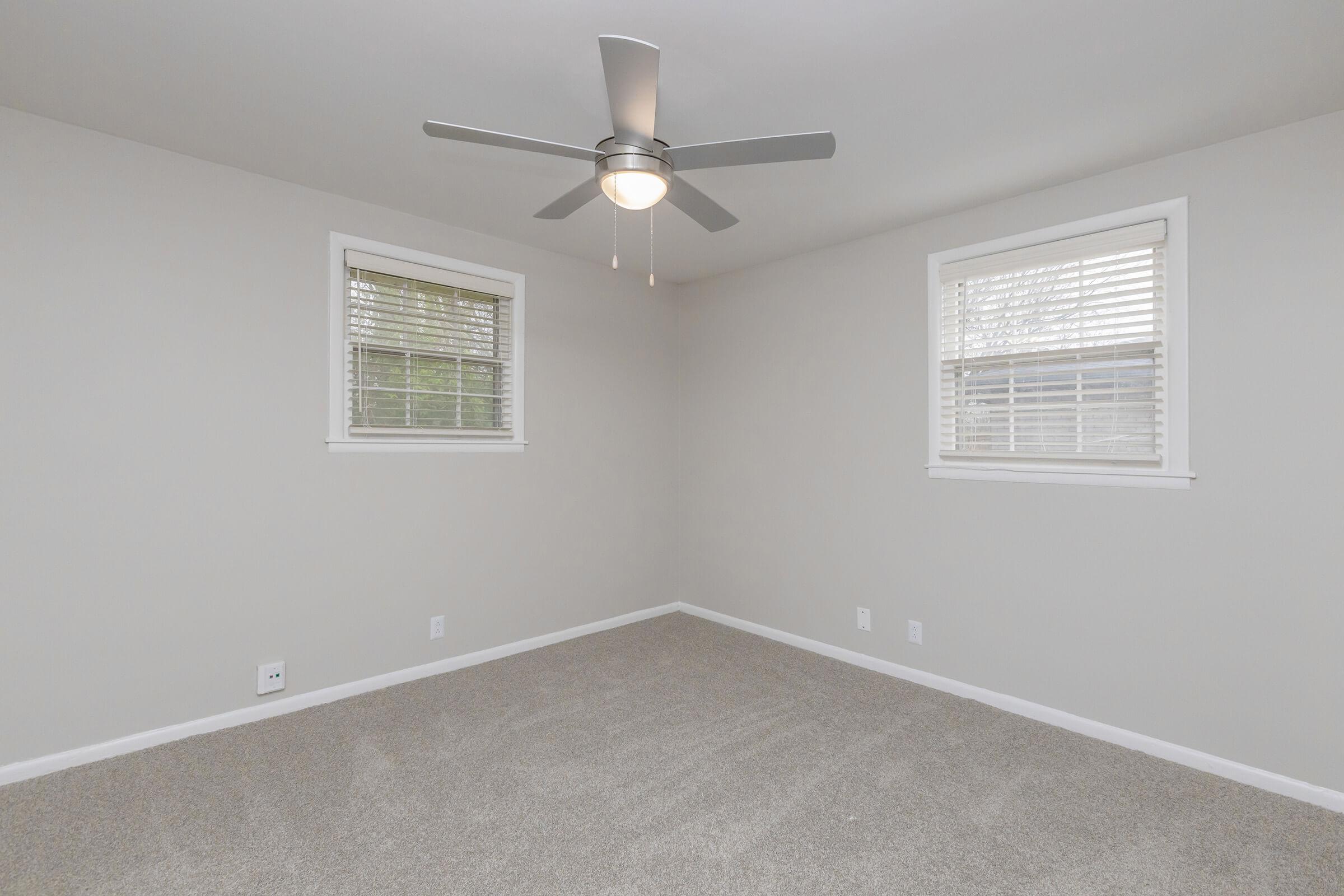 Bedroom with two windows to let in natural light.