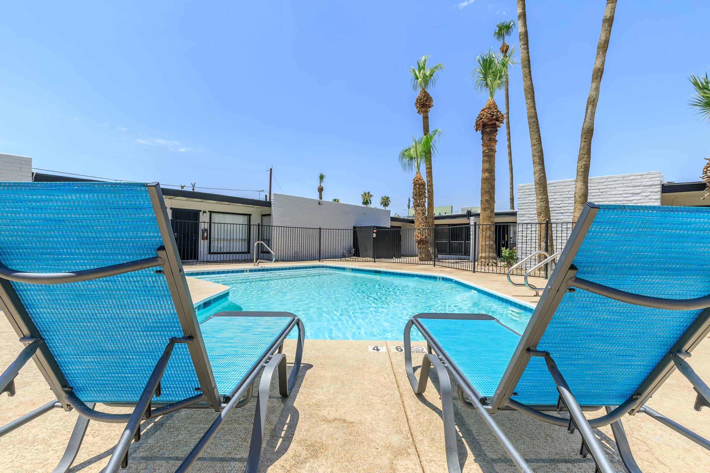 a blue chair next to a pool of water