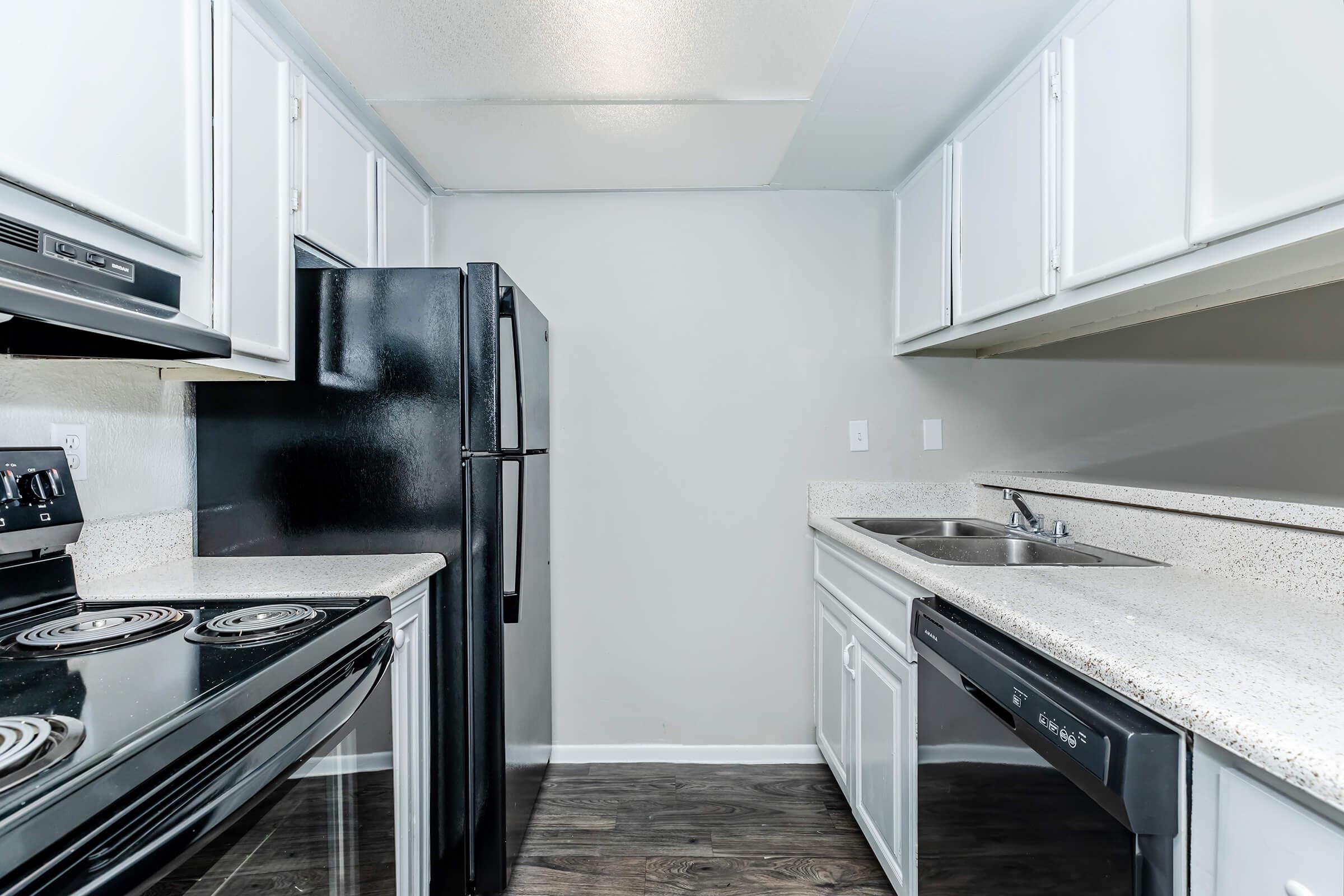 a stove top oven sitting inside of a kitchen