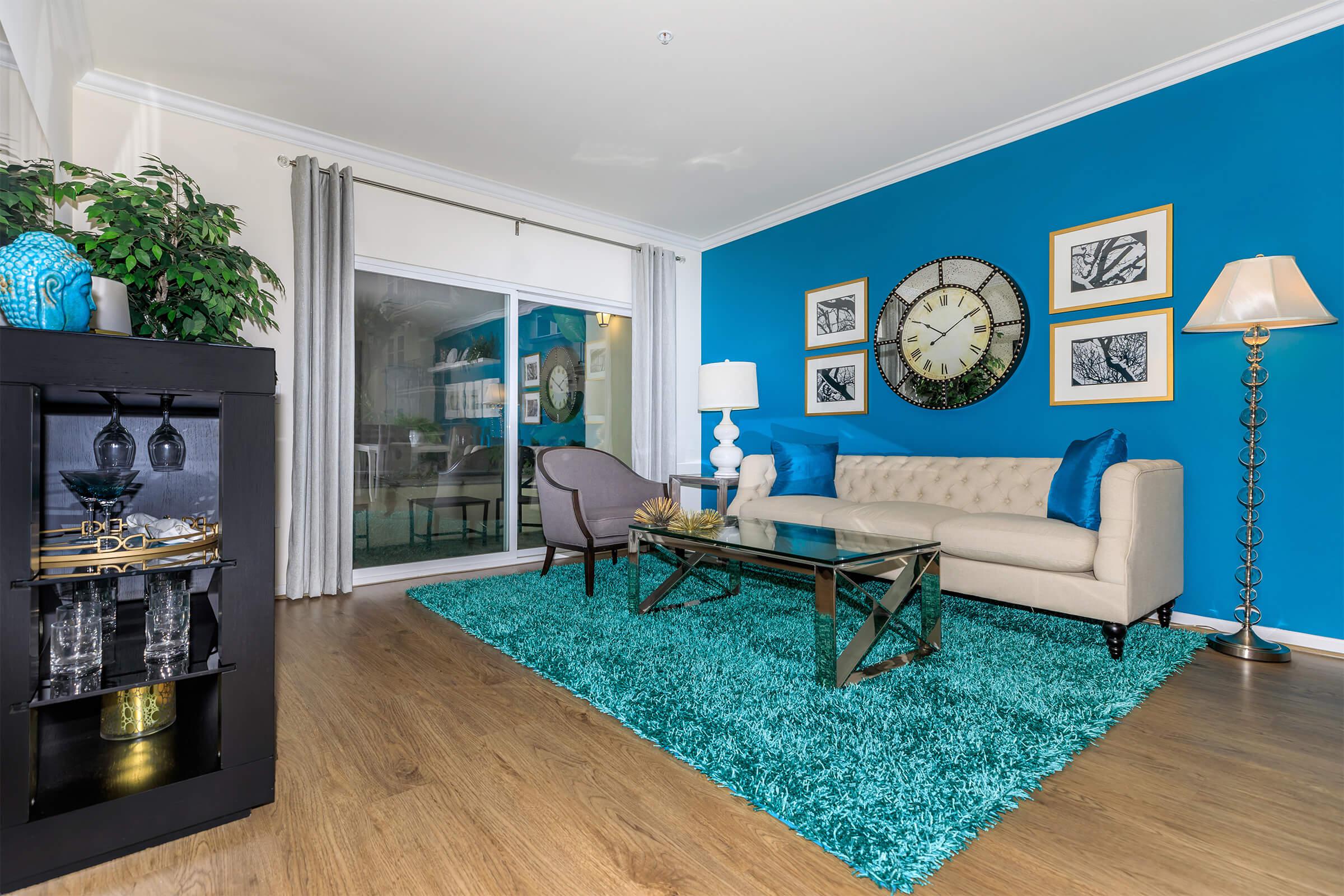 a living room filled with furniture and a large window