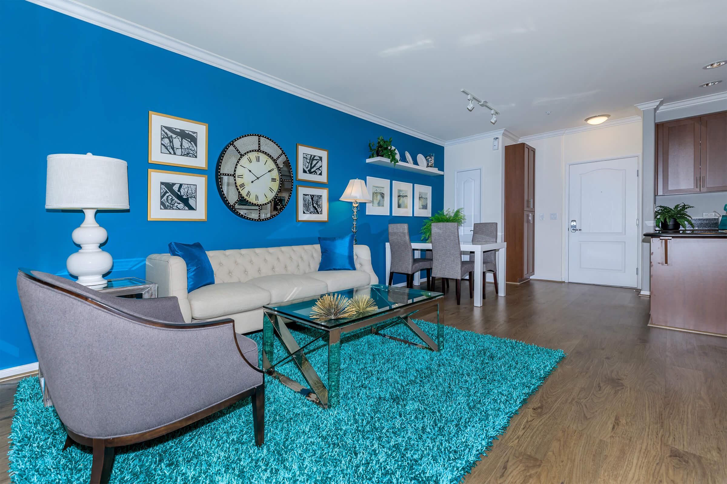 a living room with a blue chair