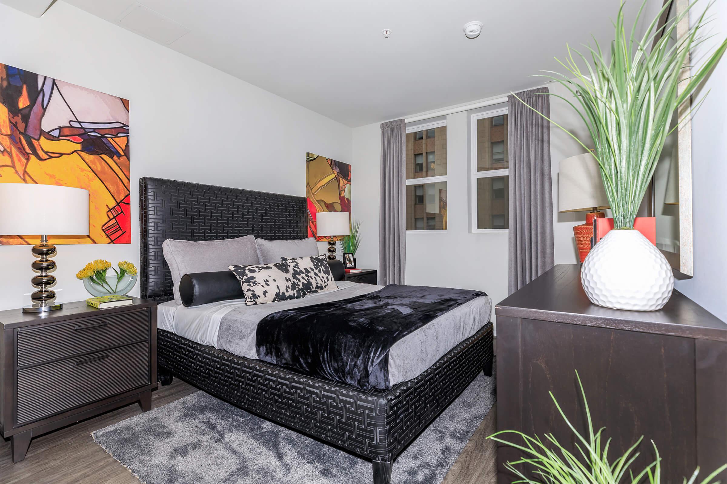 a living room with a flat screen tv sitting on top of a bed