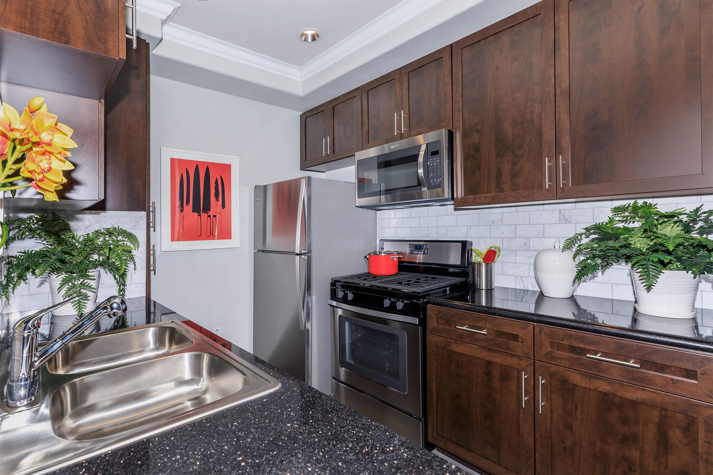 a modern kitchen with stainless steel appliances and wooden cabinets