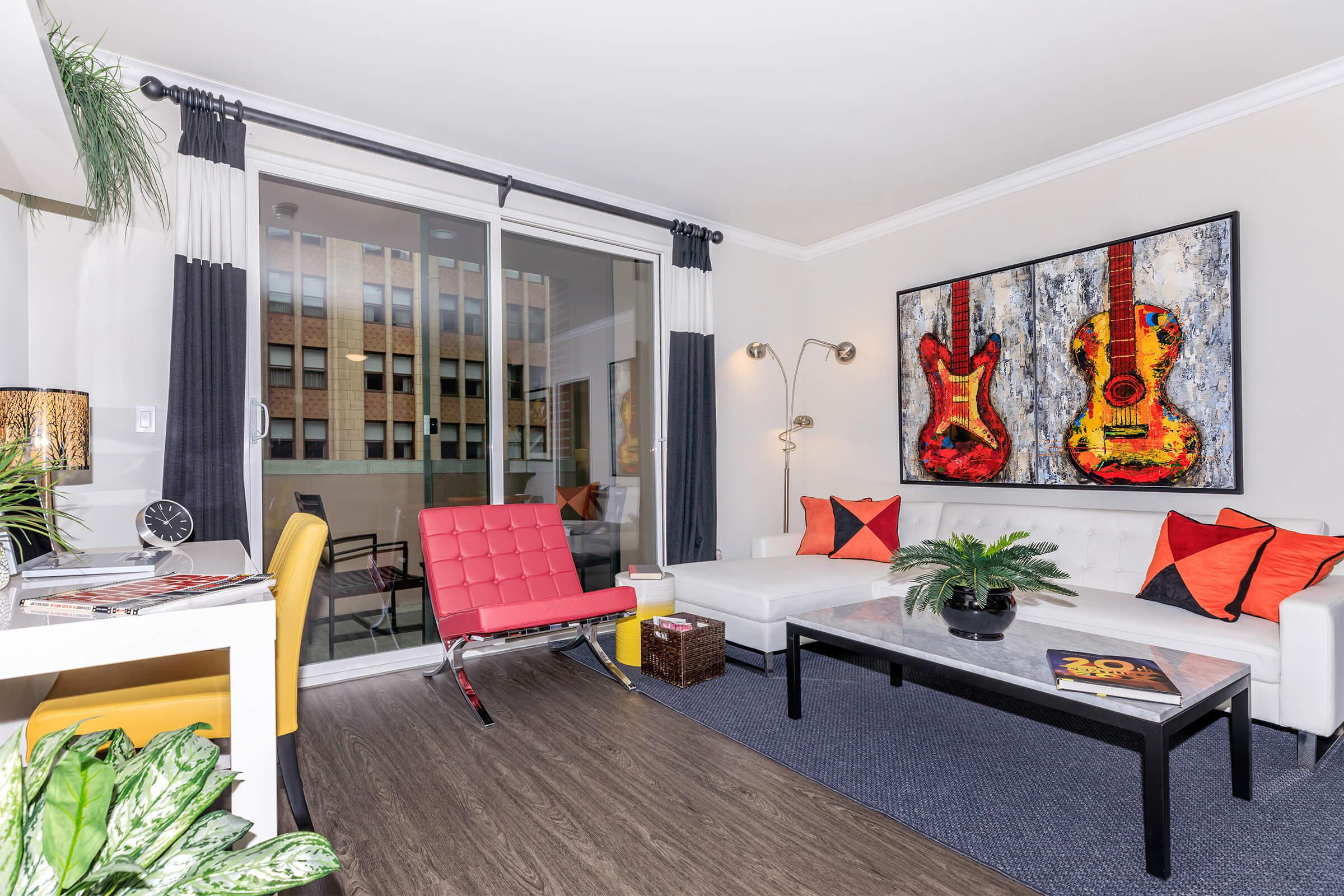 a living room filled with furniture and a large window