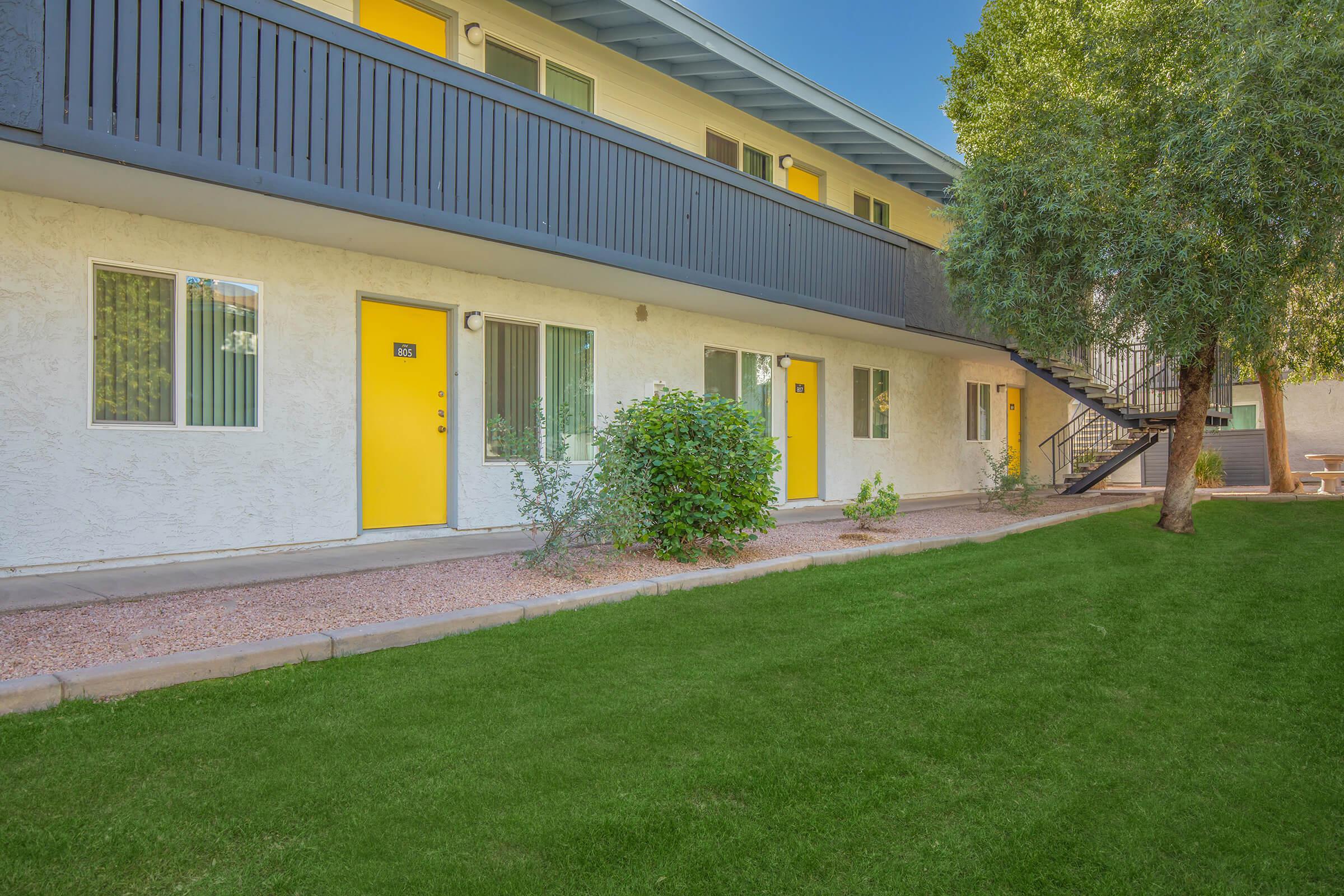 a close up of a brick building with grass in front of a house