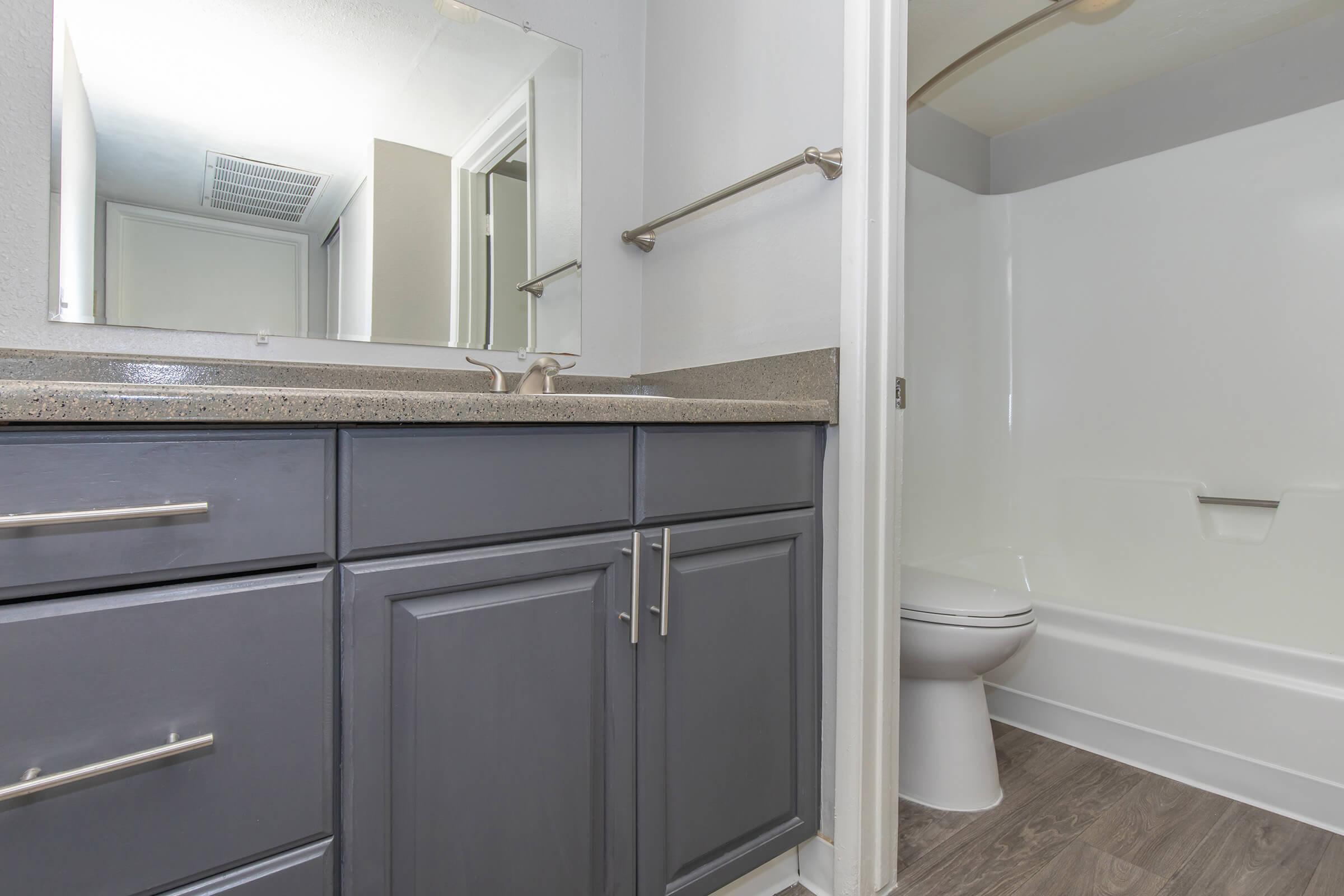 a kitchen with a sink and a mirror