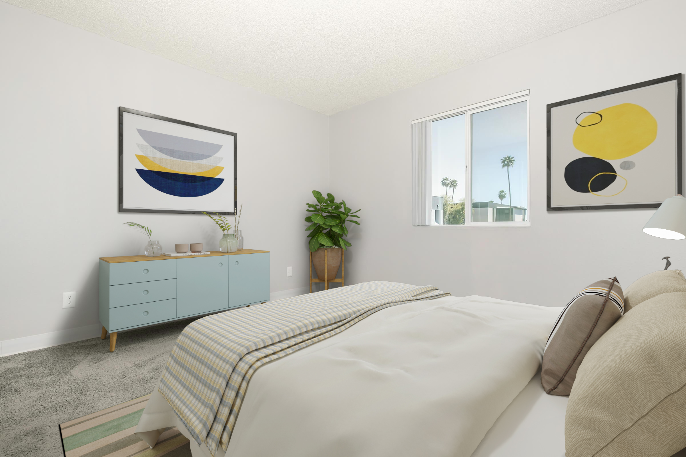 A bright, modern bedroom featuring a bed with white bedding and decorative pillows. There is a light blue dresser against the wall, a potted plant in the corner, and artwork with geometric shapes in black, yellow, and gray on the walls. A window lets in natural light, showcasing a view of palm trees outside.