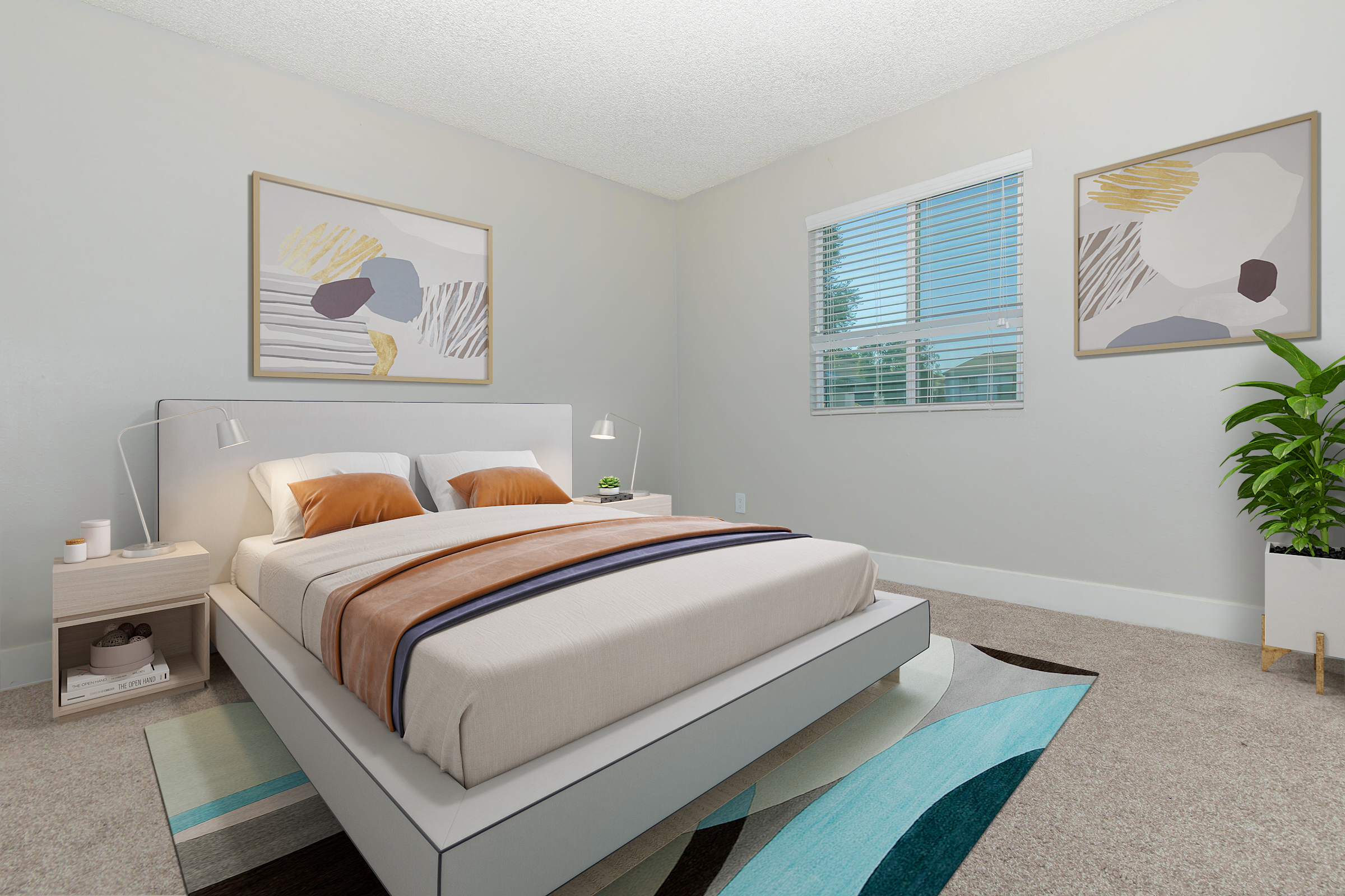 A modern bedroom featuring a double bed with neutral bedding and colorful accent pillows, a bedside table with a lamp, two abstract art pieces on the wall, a window with blinds, and a potted plant in the corner. Soft carpet and a stylish area rug complete the cozy atmosphere.
