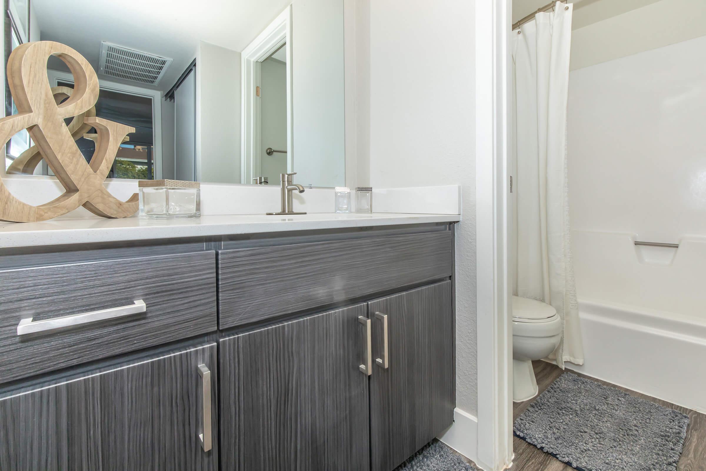 a kitchen with a sink and a mirror