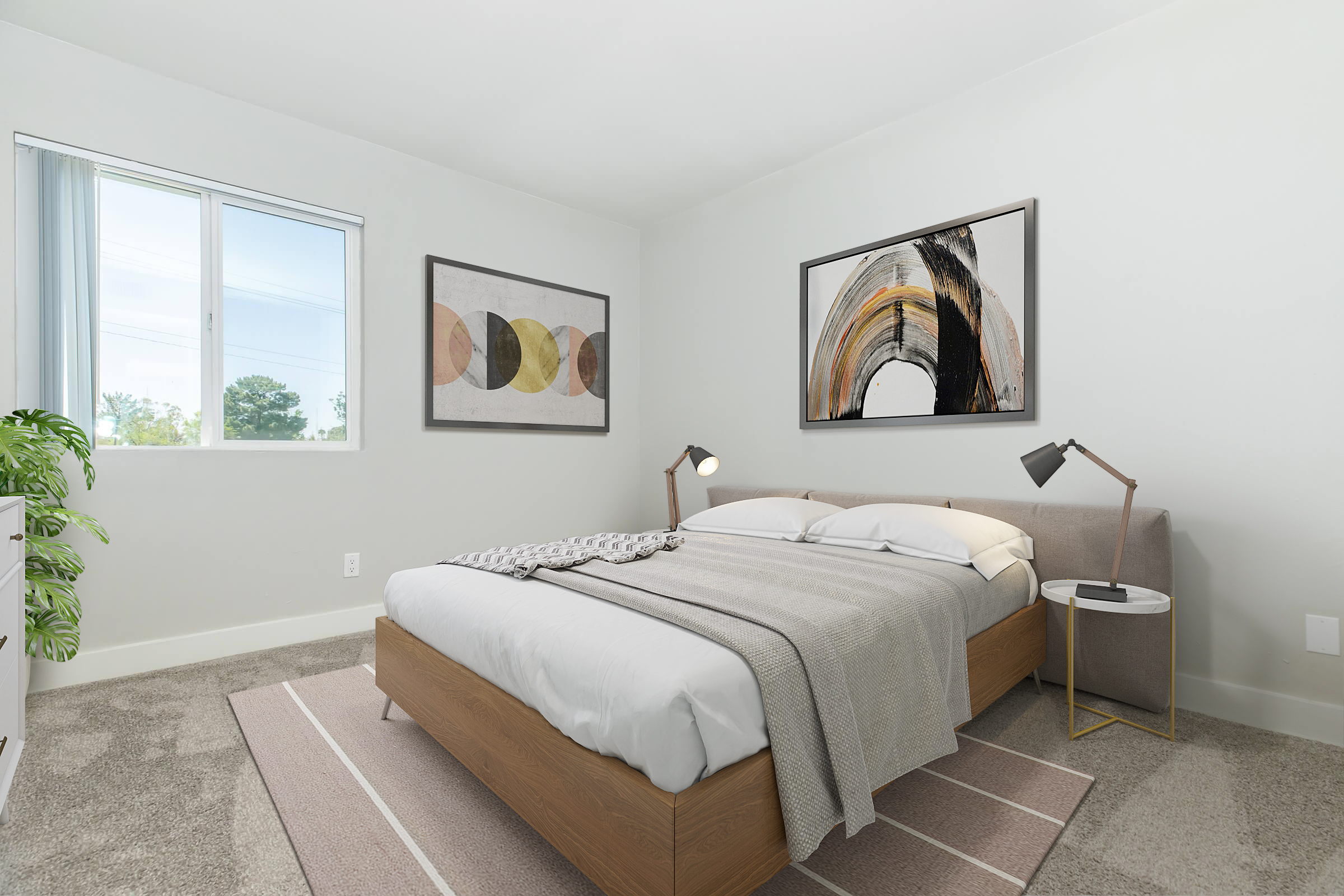 A modern, minimalist bedroom featuring a queen-sized bed with a light gray blanket and decorative pillows, flanked by bedside tables with stylish lamps. The walls are adorned with abstract art pieces, and a large window lets in natural light. A potted plant adds a touch of greenery to the space.