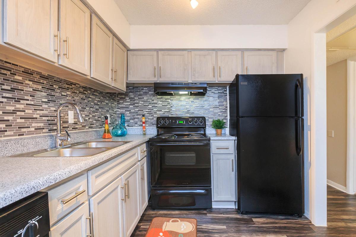 a kitchen with stainless steel appliances and wooden cabinets