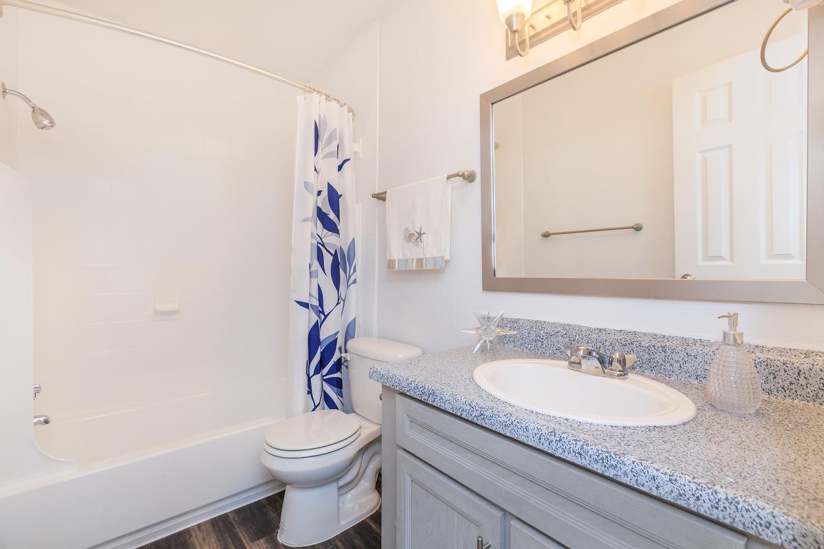 a large white tub next to a sink