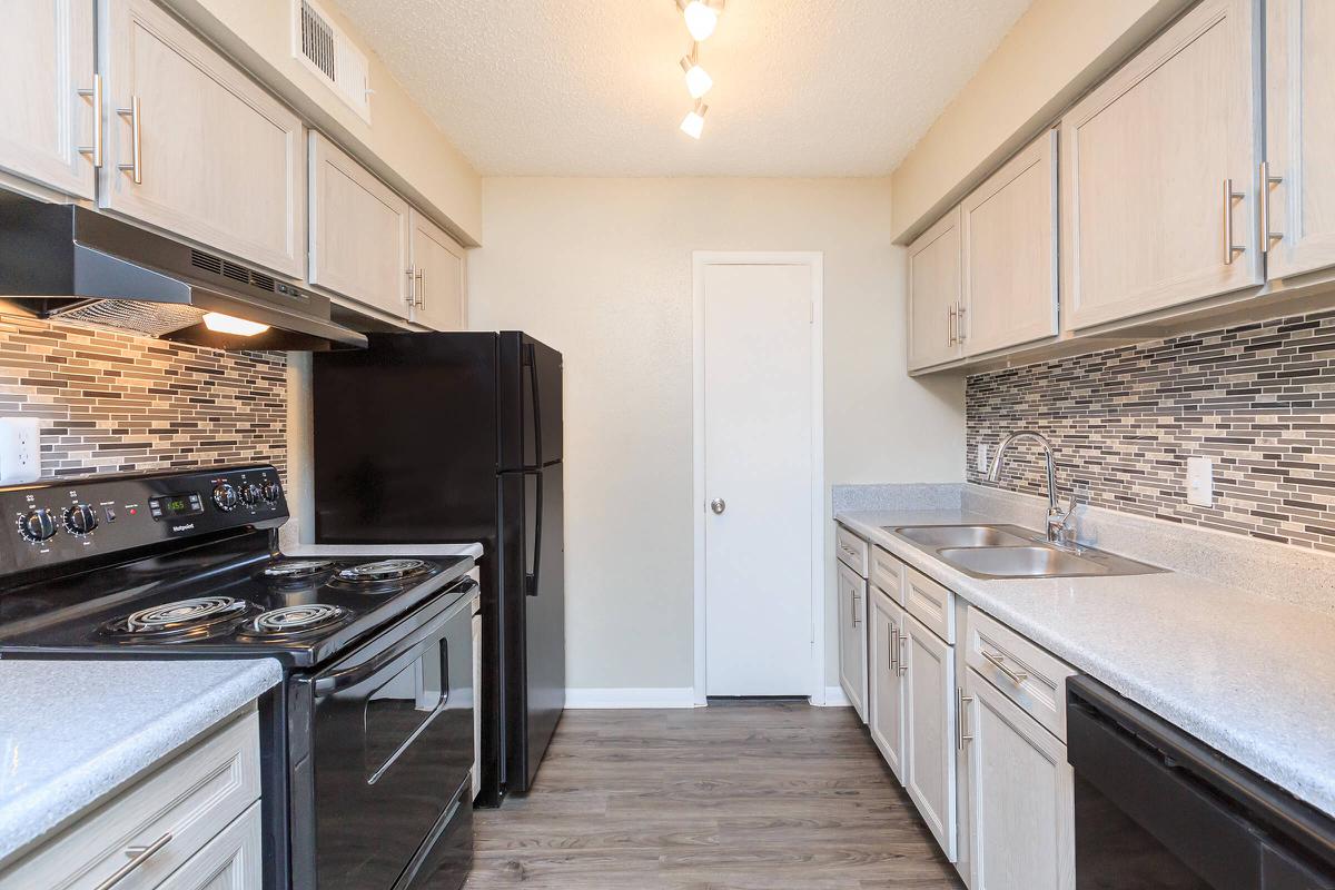 a kitchen with a stove top oven