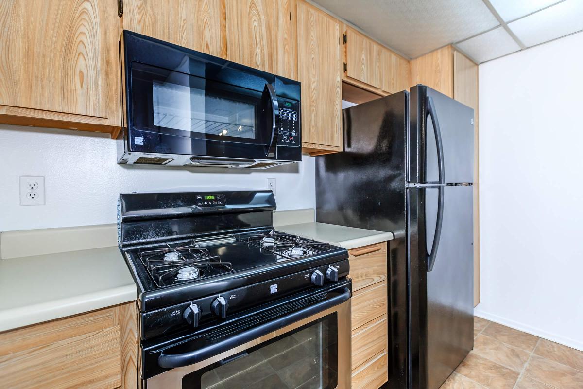 a black stove top oven sitting inside of a kitchen