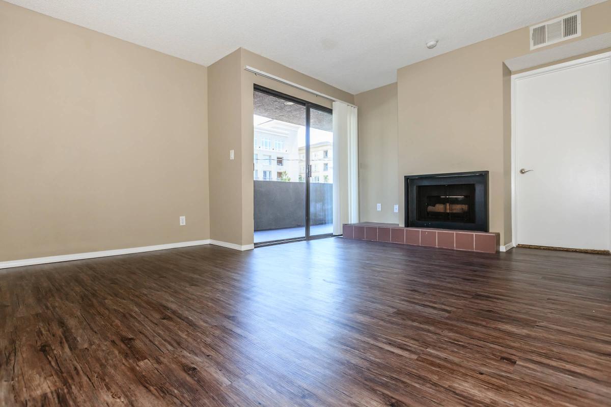 a large empty room with a wood floor