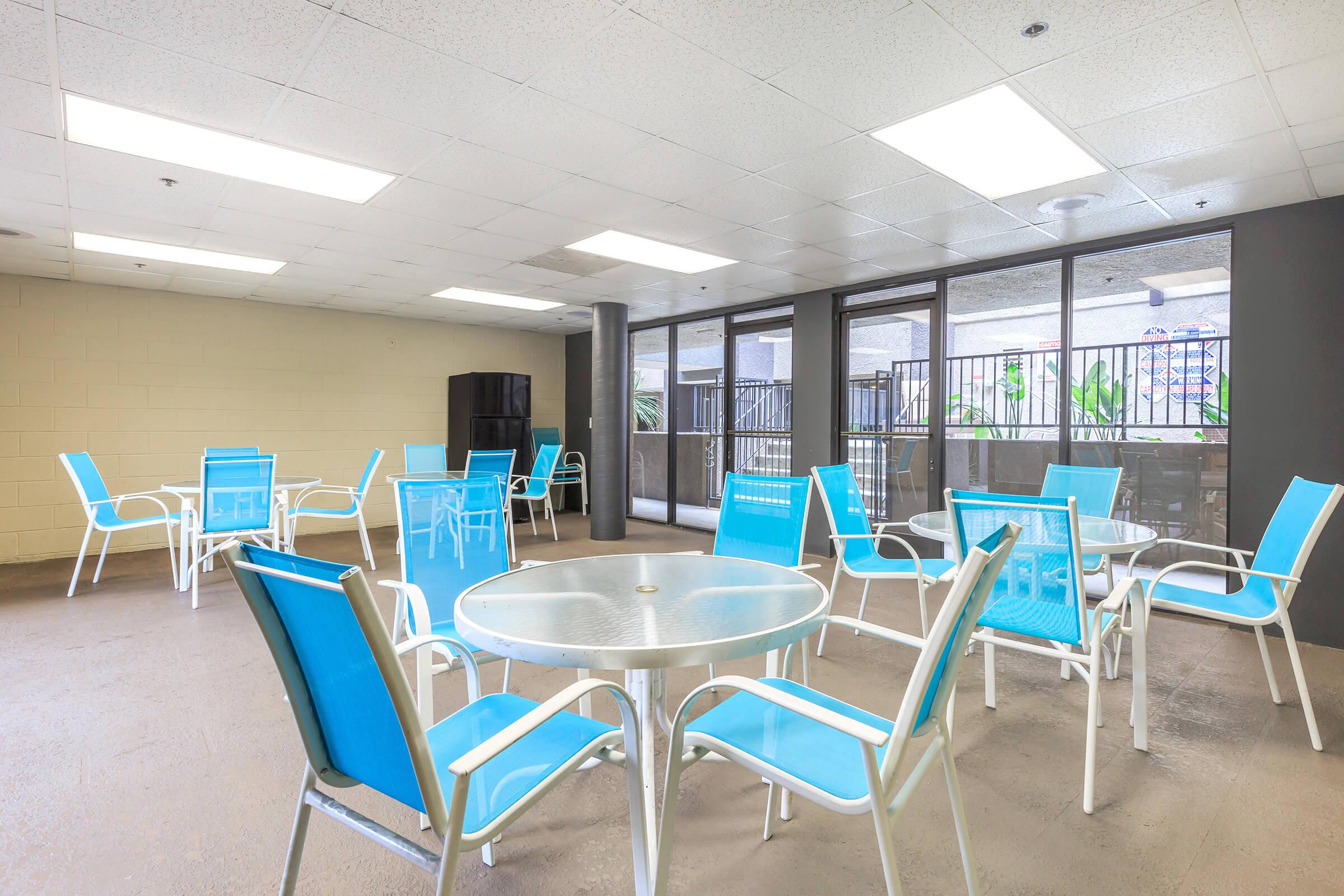 a dining room table with a blue chair