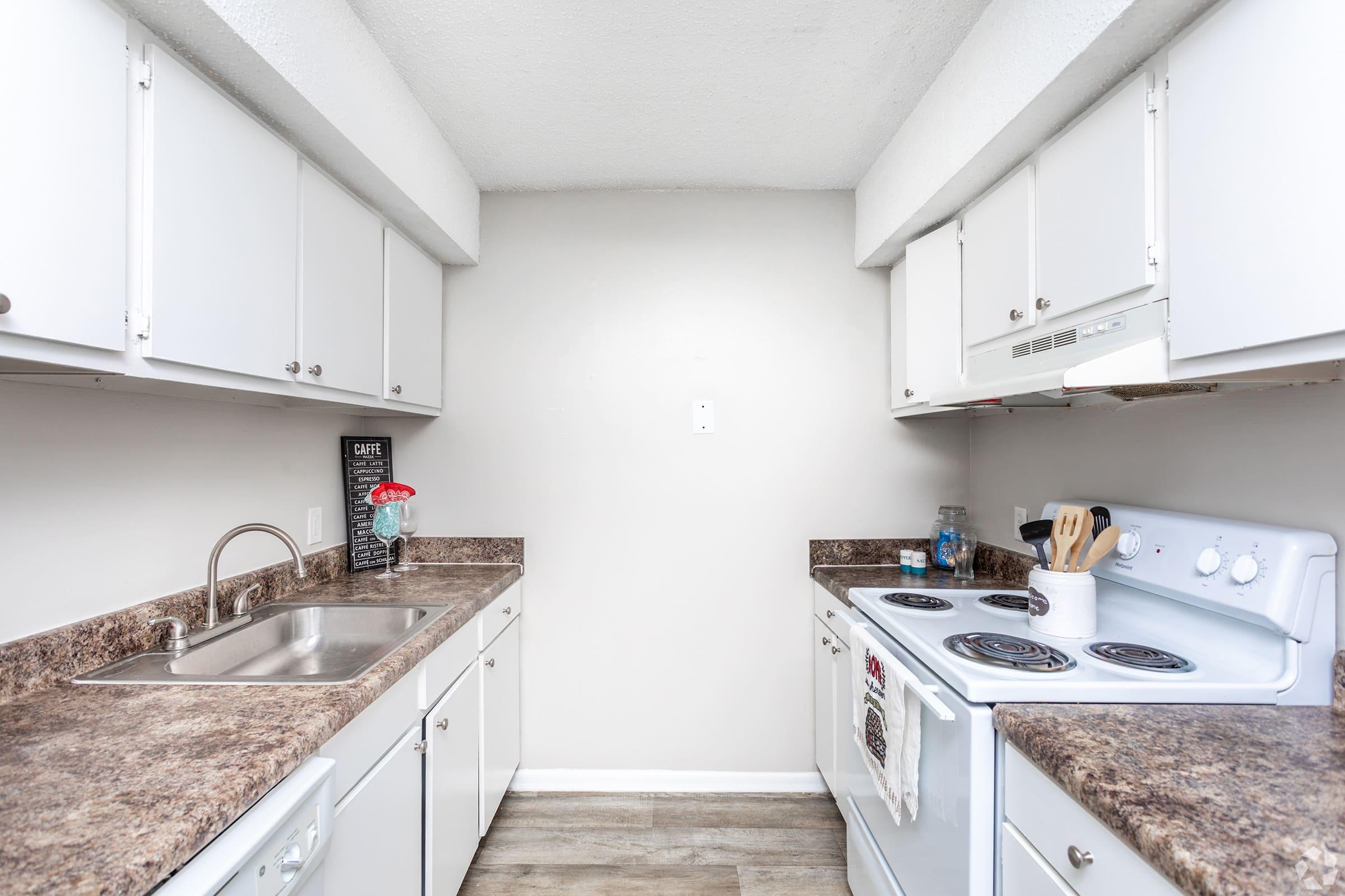 a kitchen with a stove a sink and a microwave