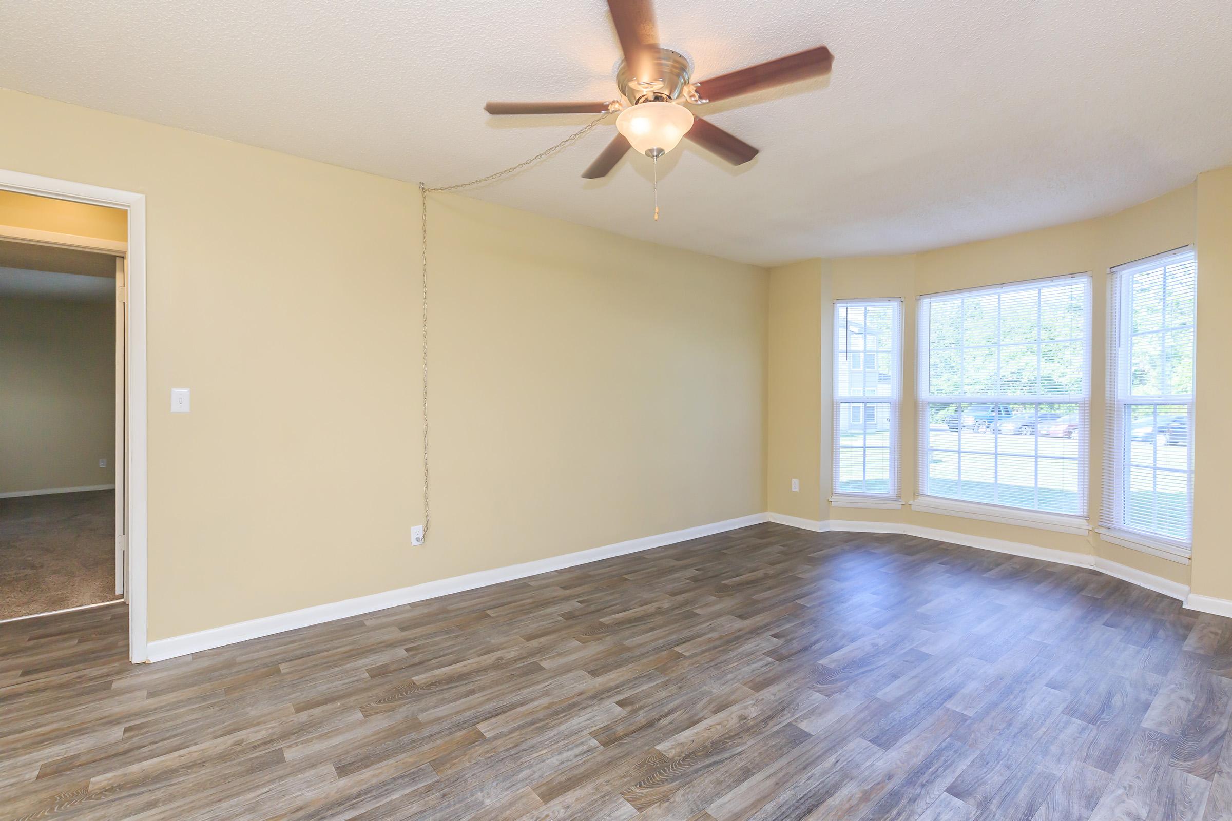 a large empty room with a wooden floor