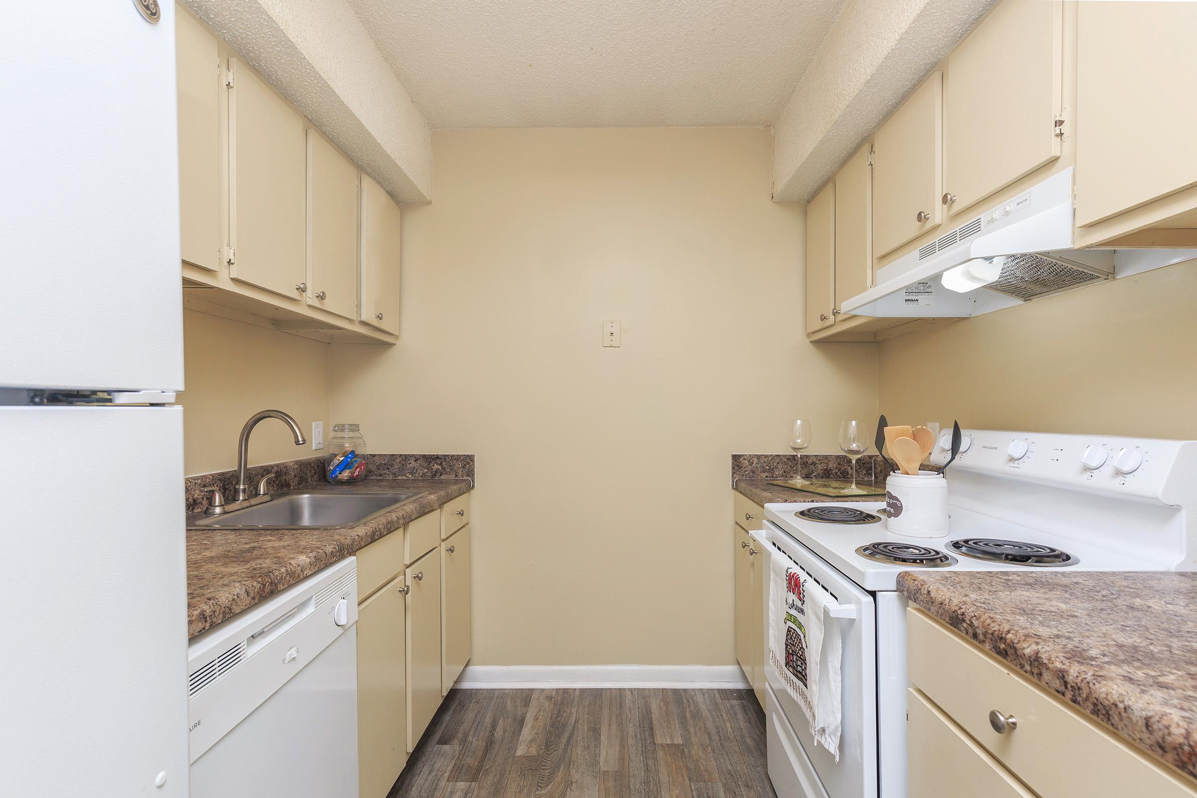 a kitchen with a stove sink and refrigerator