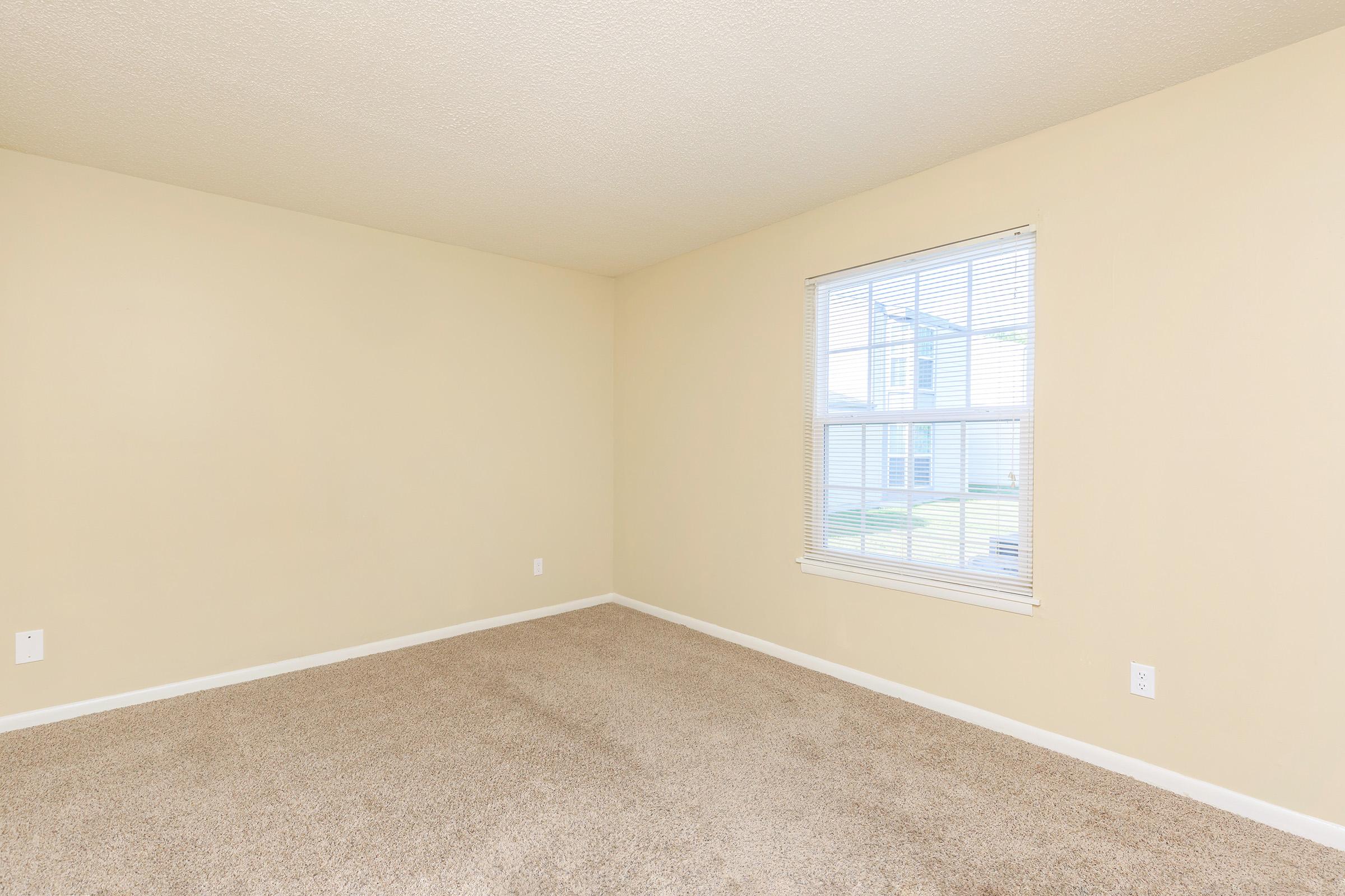 a bedroom with a large window