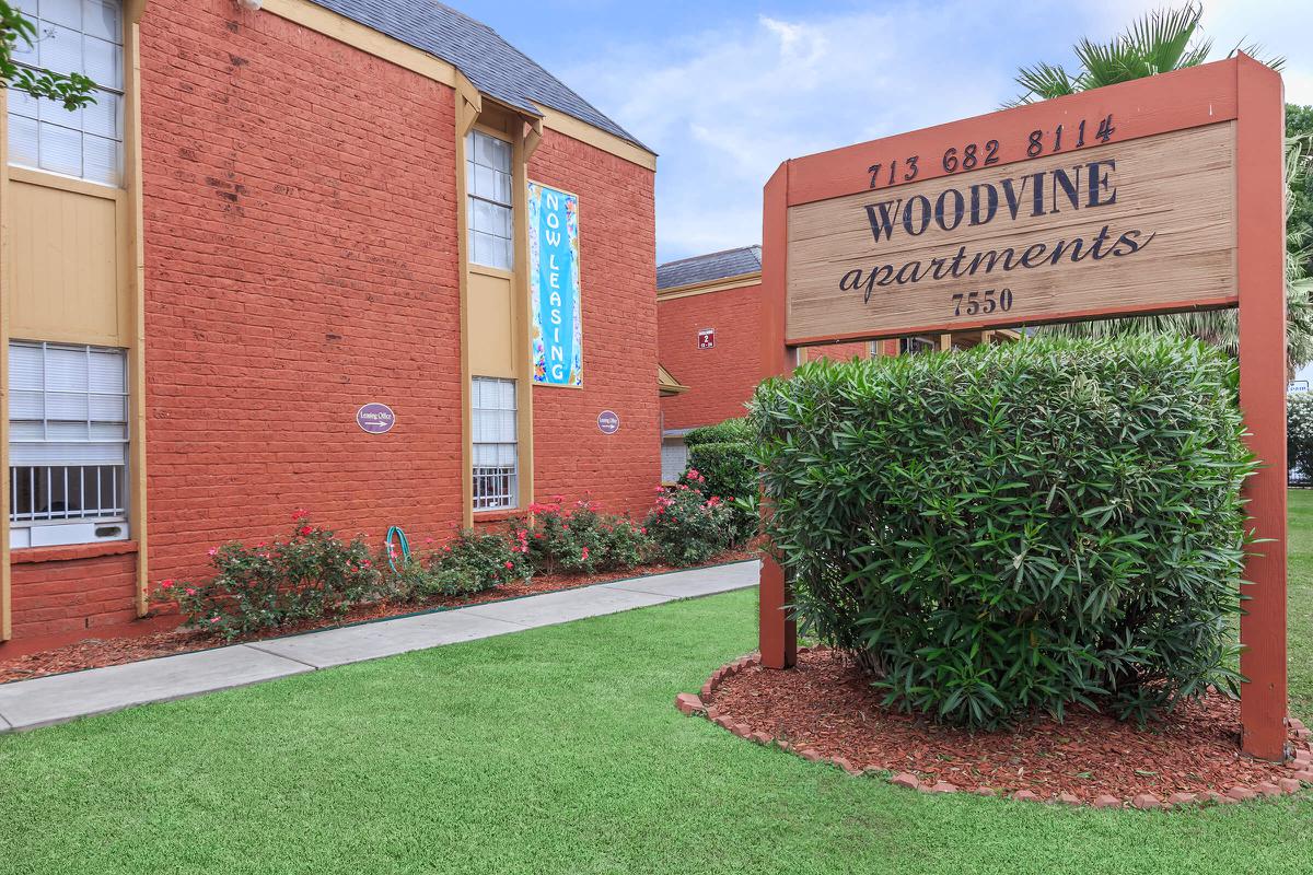 a sign in front of a brick building