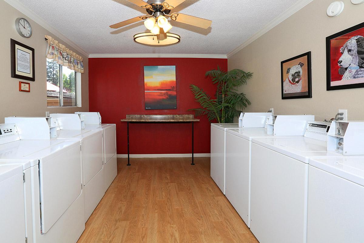 a kitchen with a sink and a mirror in a room