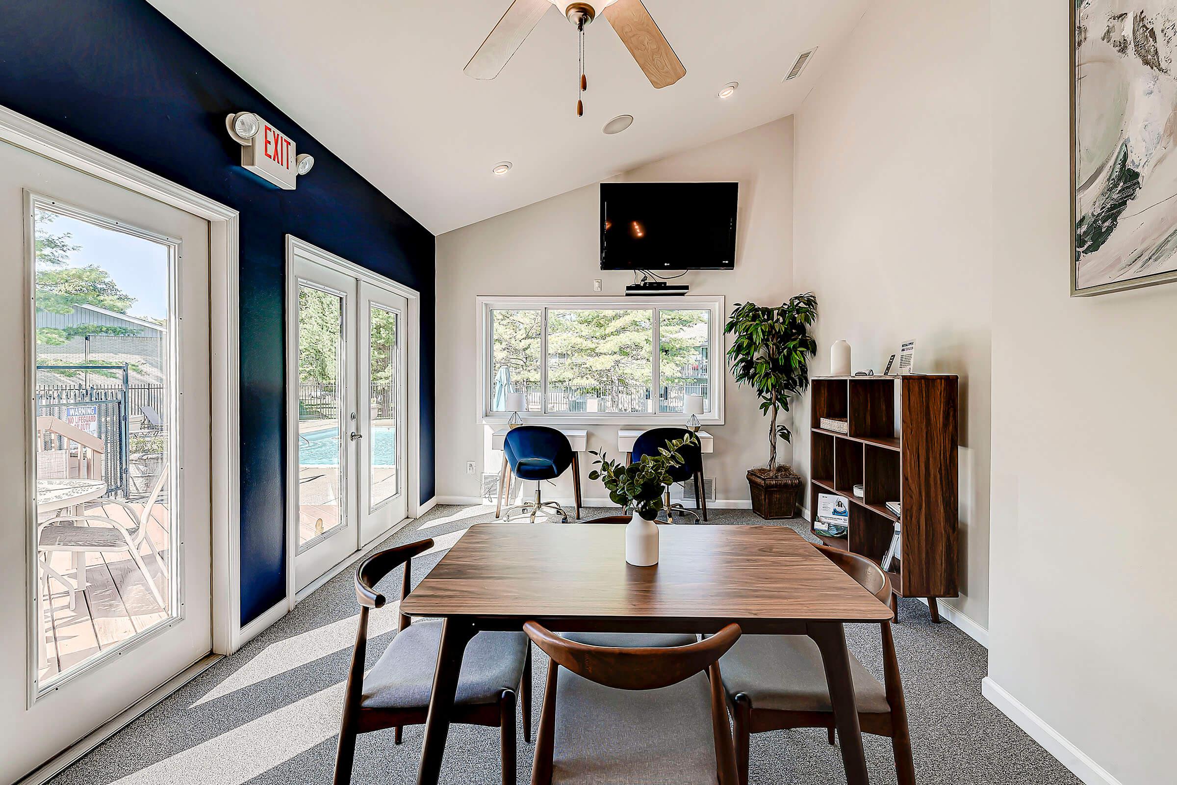 a living room filled with furniture and a large window