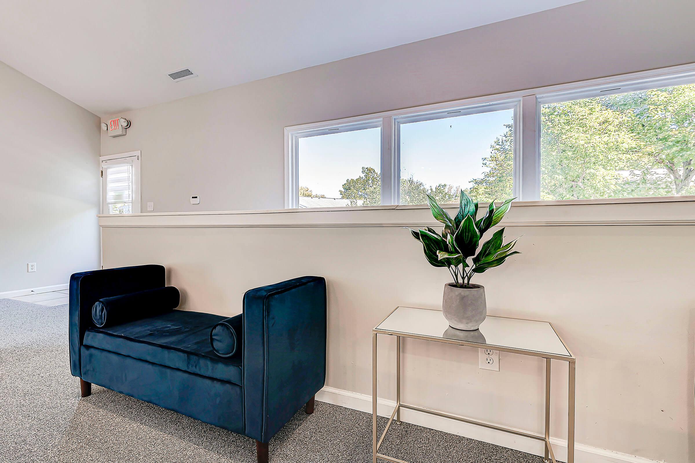 a living room filled with furniture and a large window