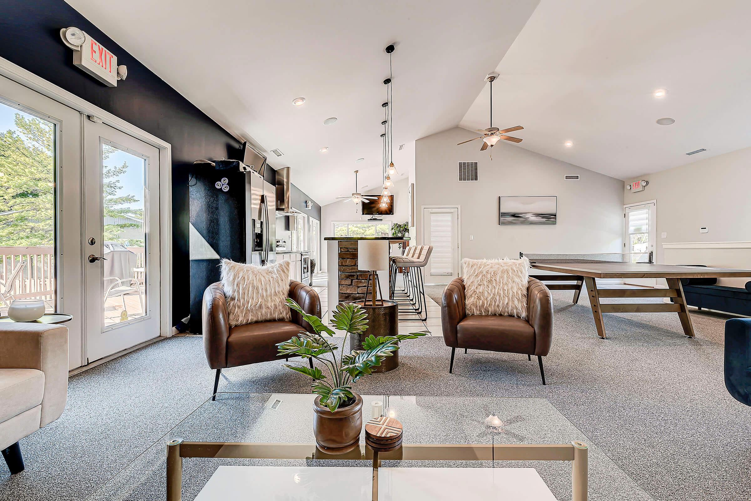 a living room filled with furniture and a large window