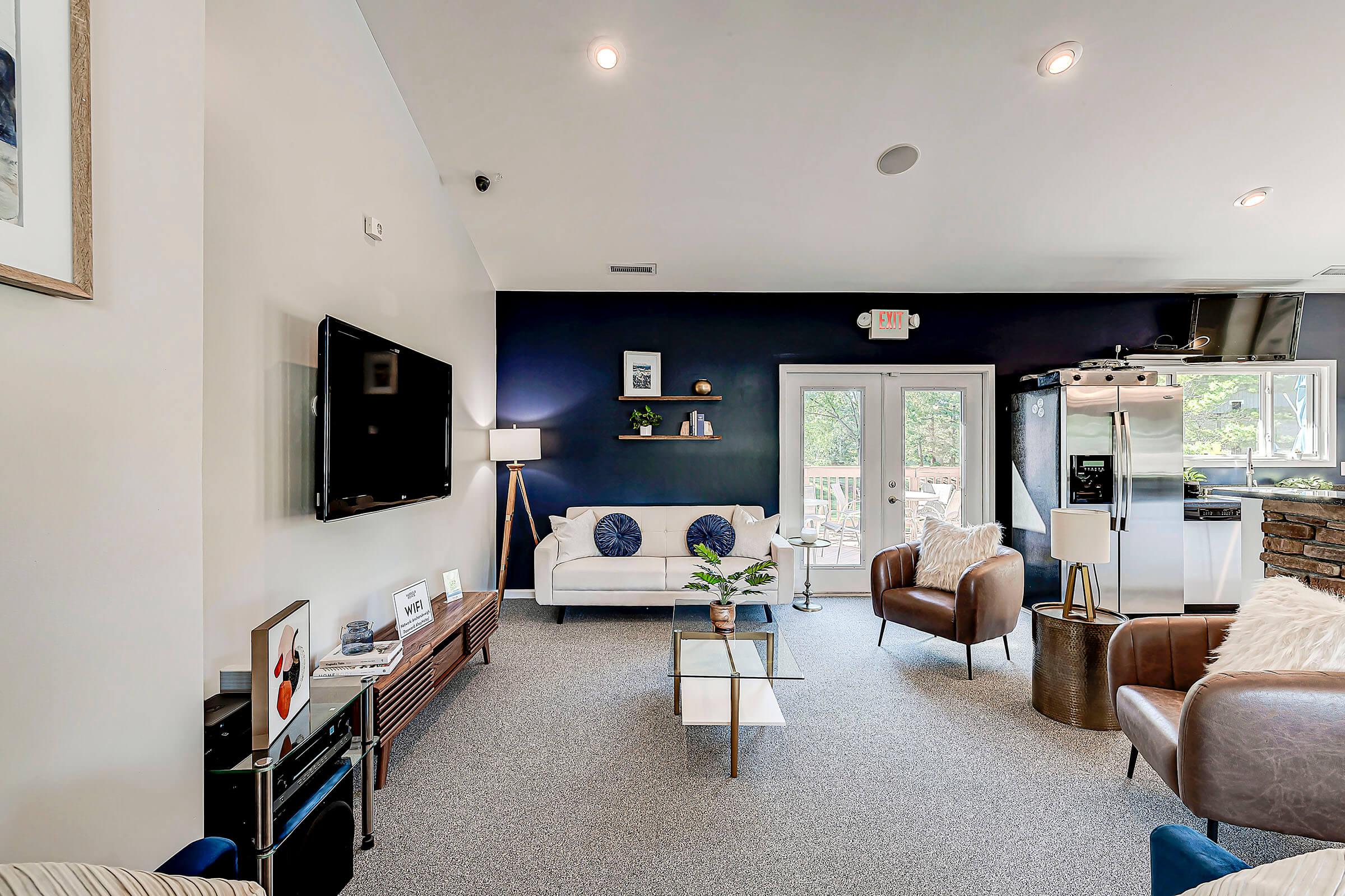 a living room filled with furniture and a large window