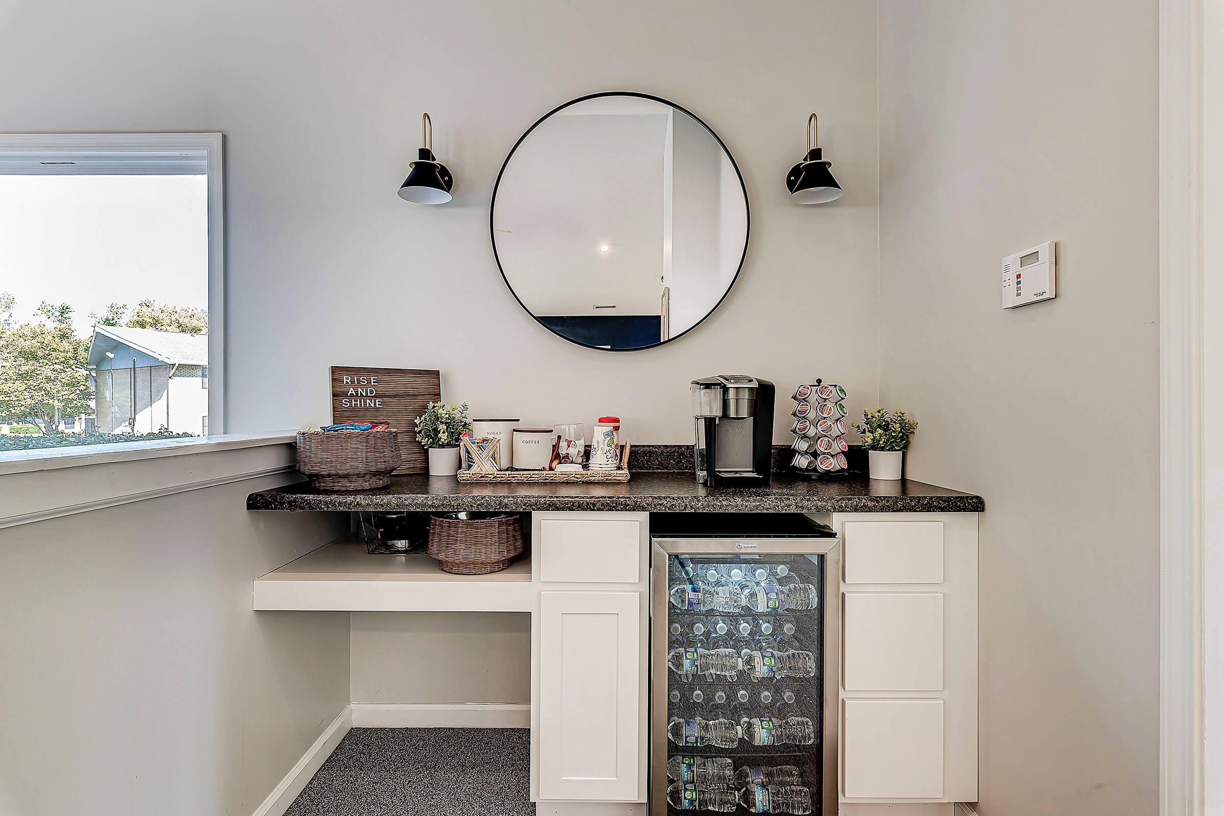 a kitchen with a sink and a mirror