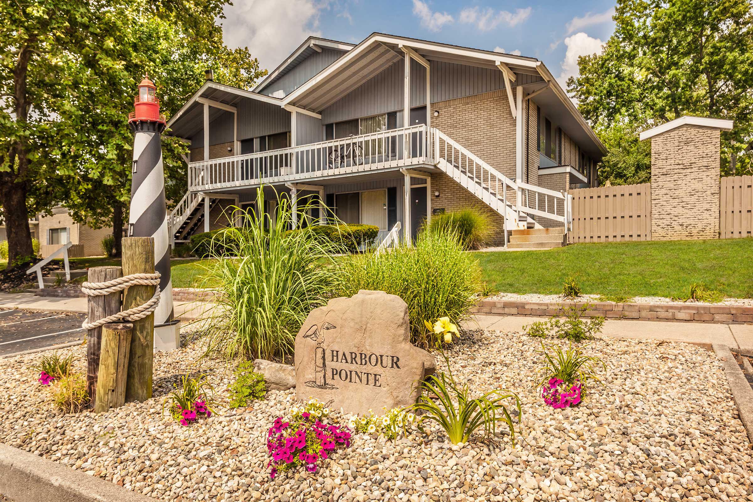 a close up of a flower garden in front of a house