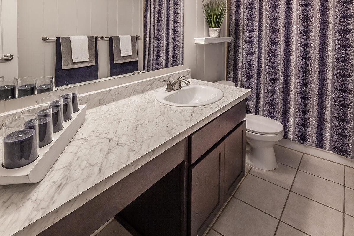 a large white tub next to a sink