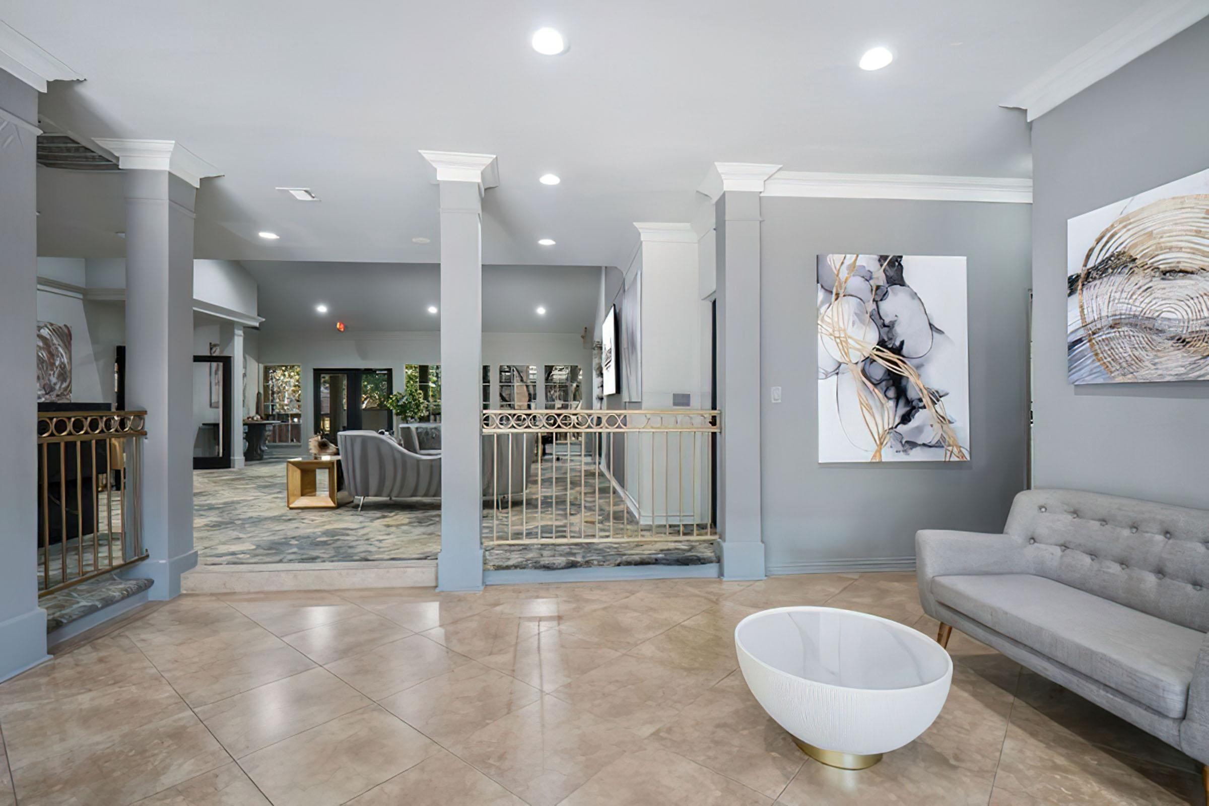 a living room filled with furniture and a large mirror