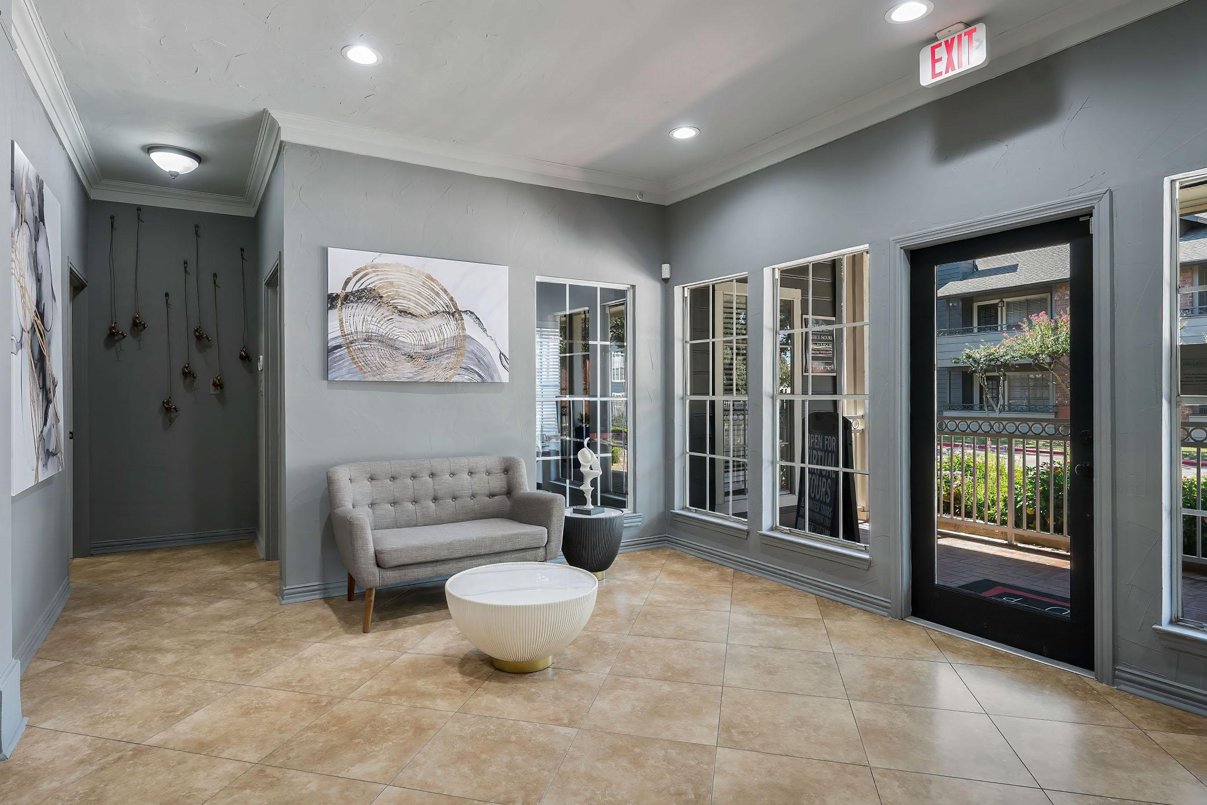 a living room filled with furniture and a large window