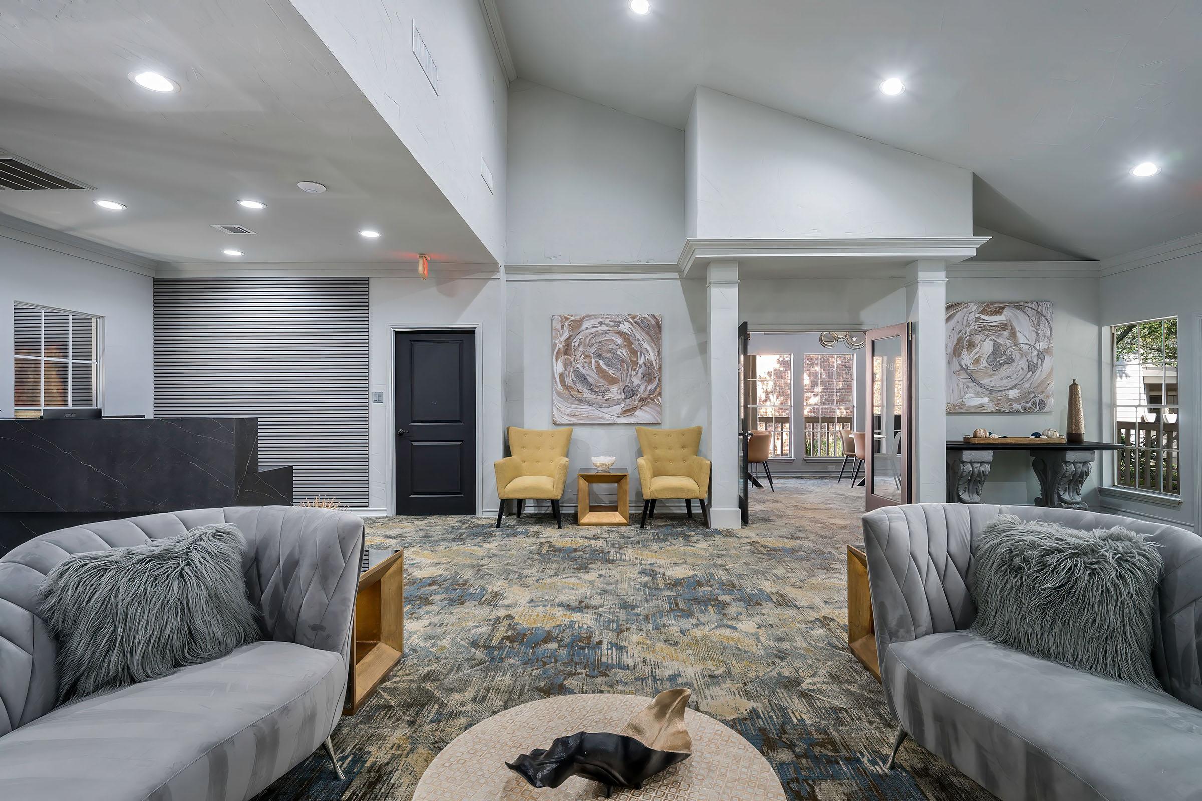 a living room filled with furniture and a large window