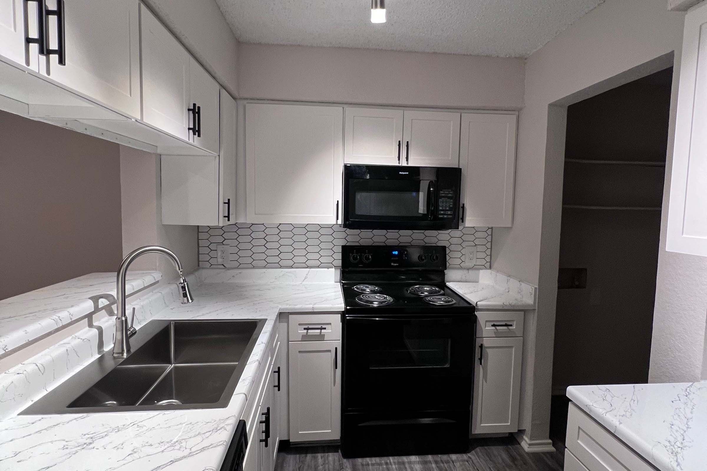 a stove top oven sitting inside of a kitchen