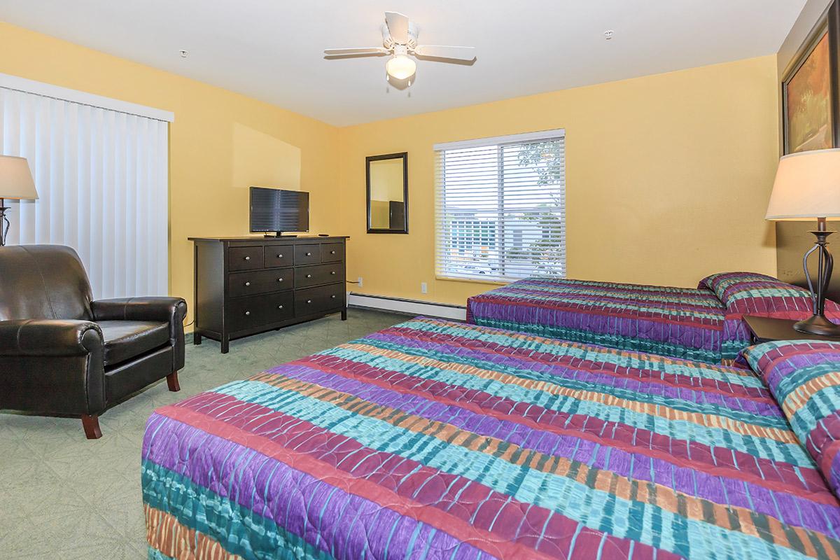 a bedroom with a bed in a room