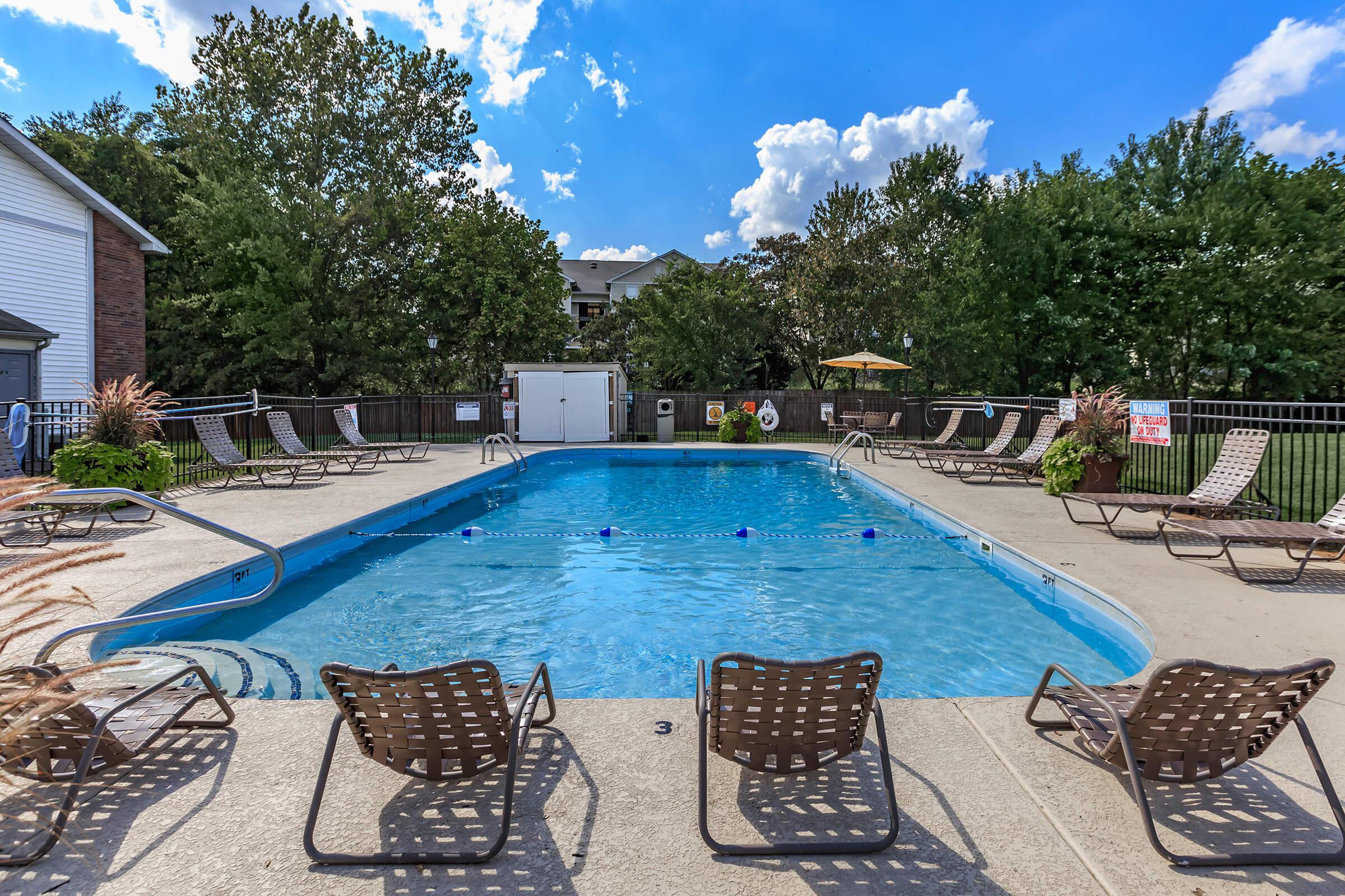 a group of lawn chairs sitting on top of a pool