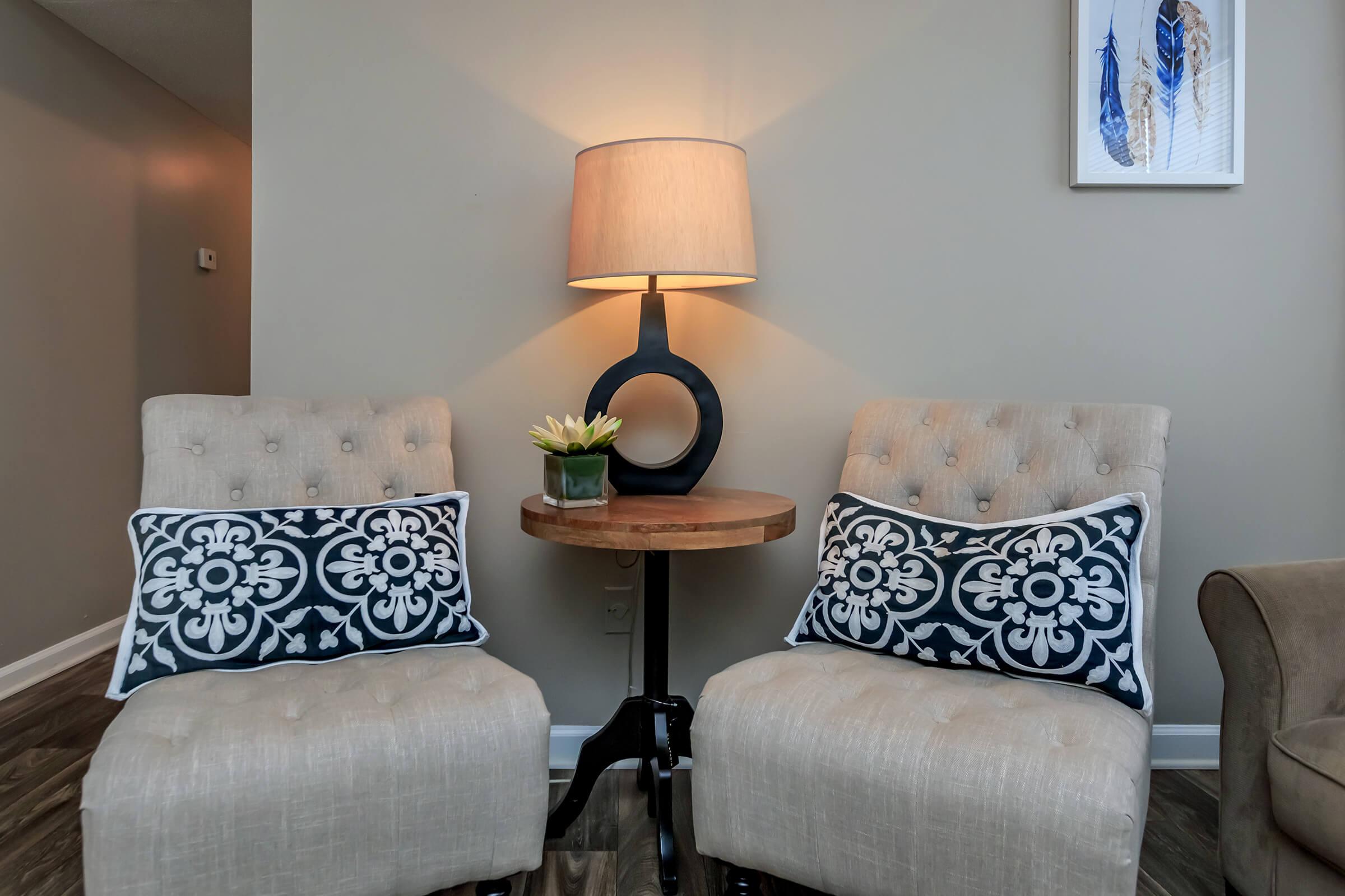 a living room filled with furniture and a lamp