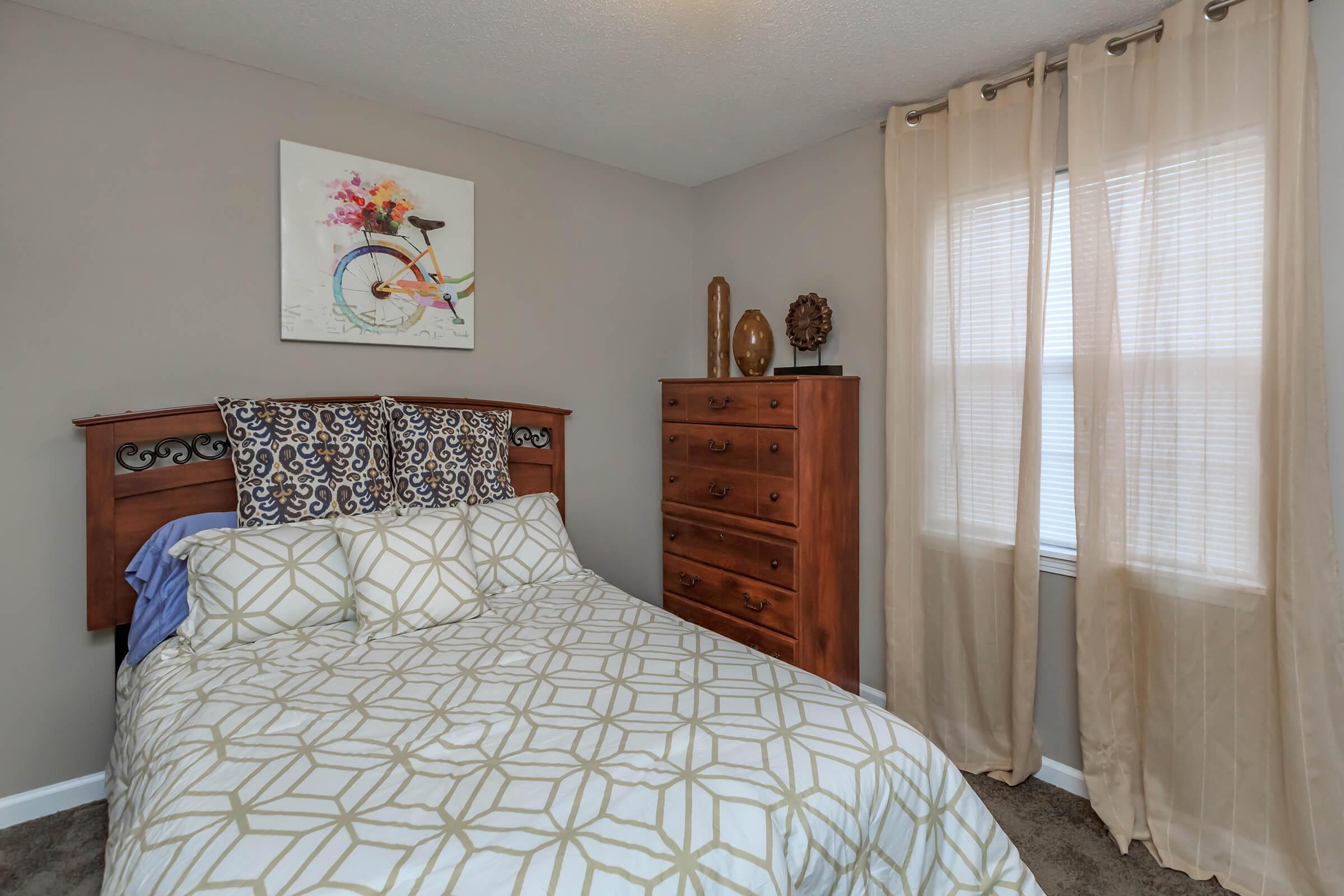 a bedroom with a bed in a room