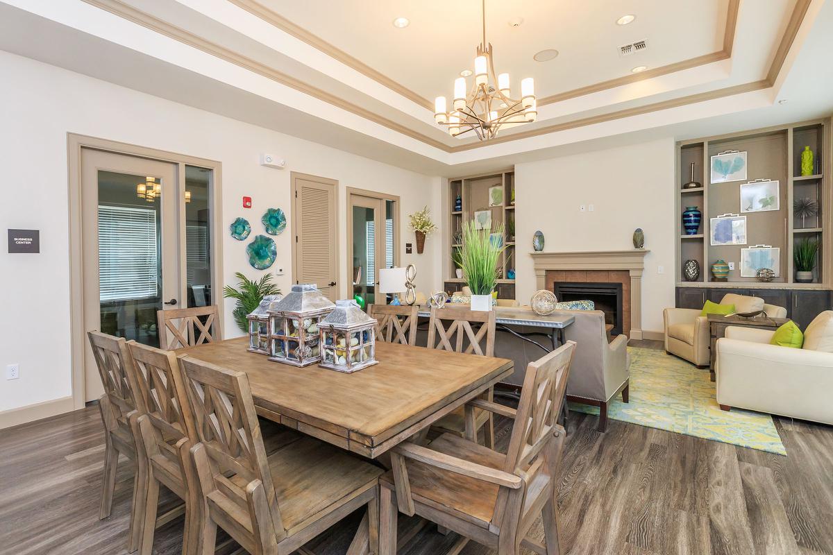 a room filled with furniture and vase of flowers on a table