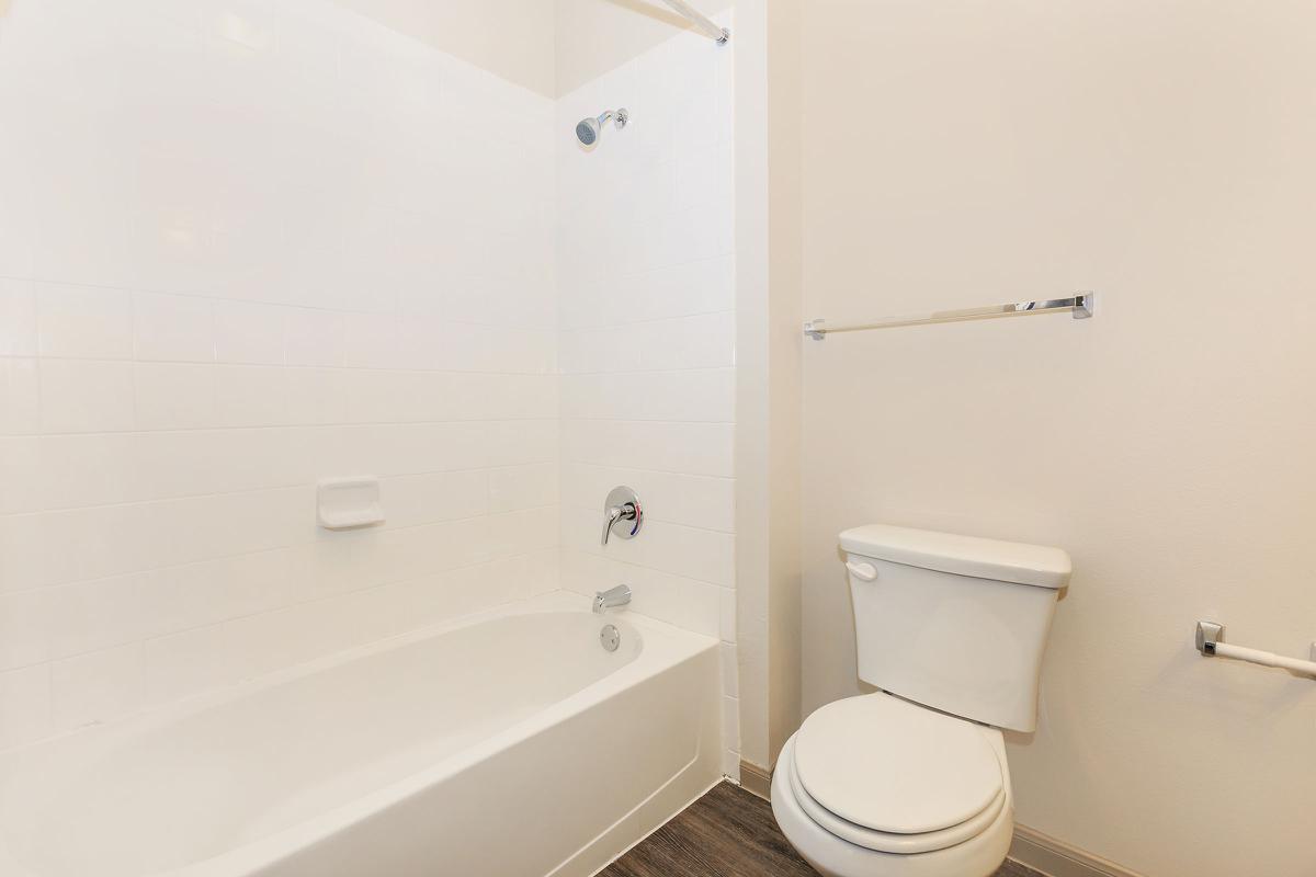 a white tub sitting next to a shower