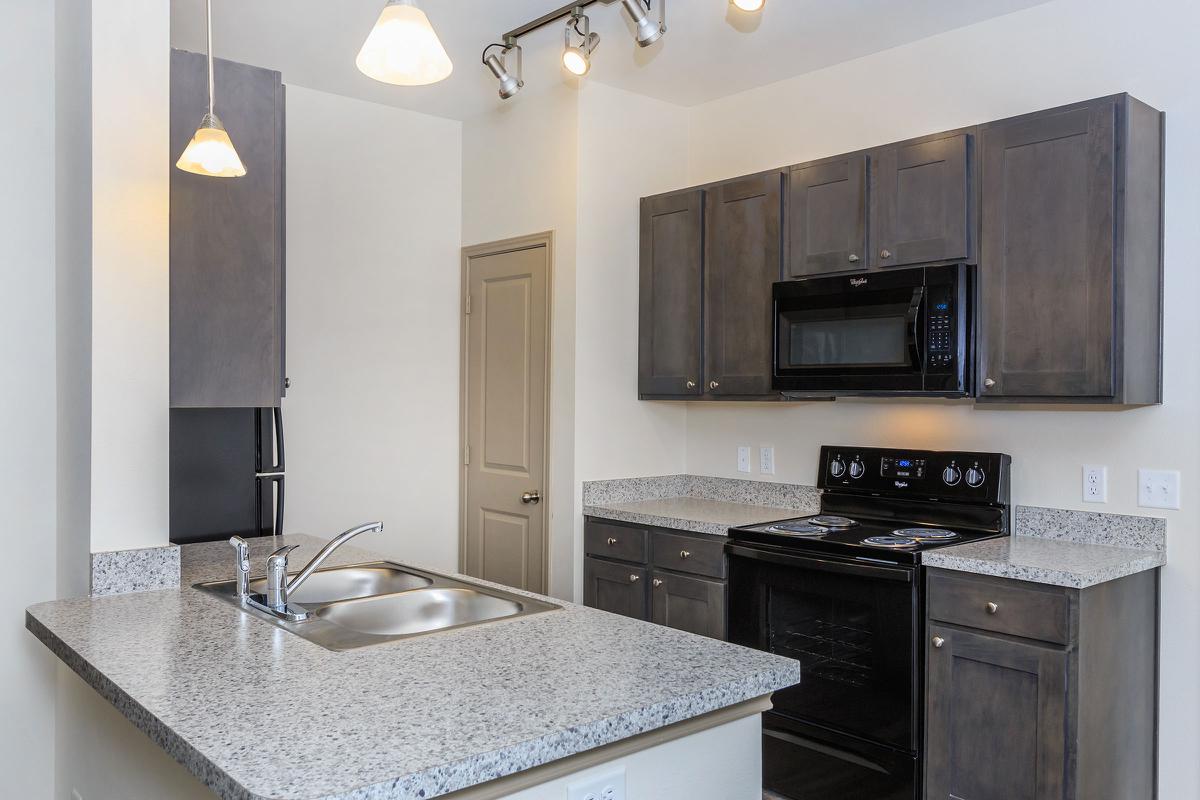 a kitchen with a sink and a mirror