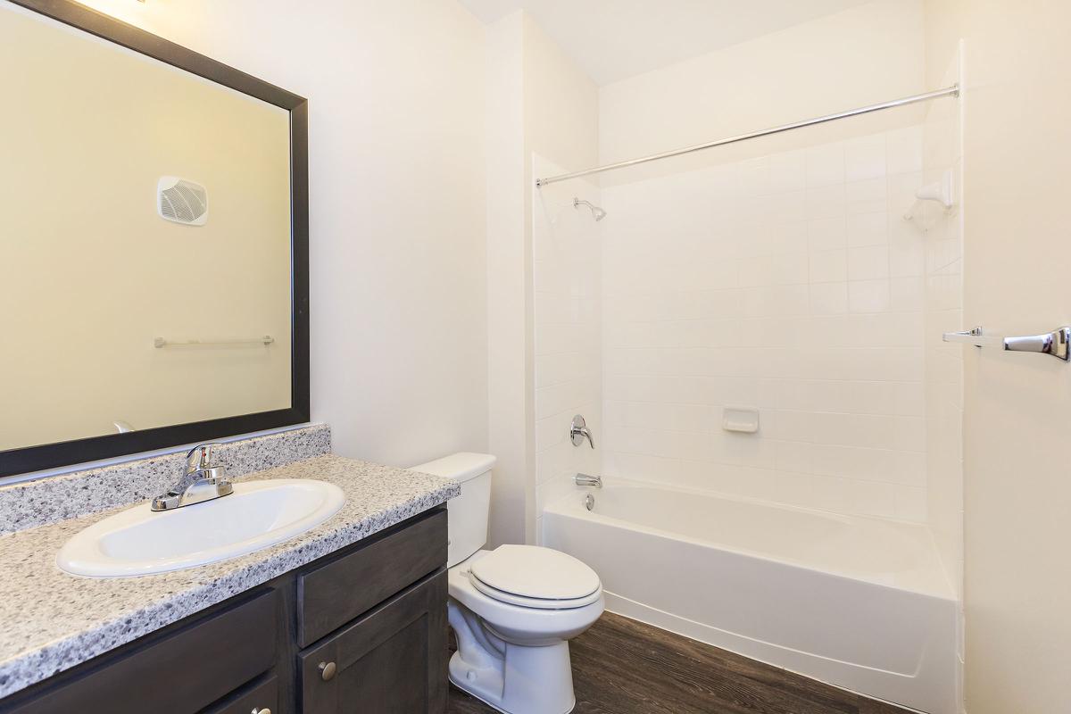 a white sink sitting next to a shower