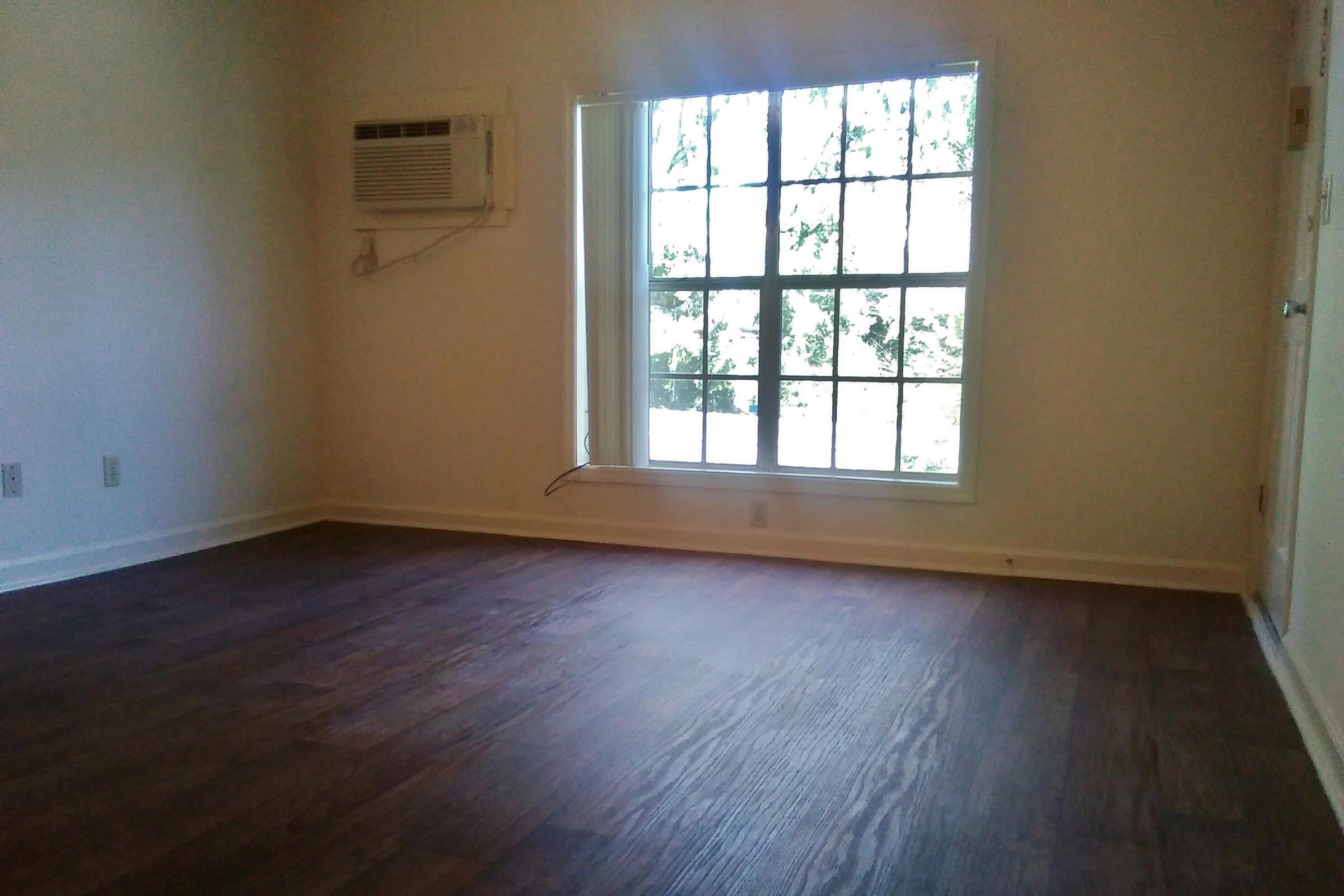 a large empty room with a wooden floor