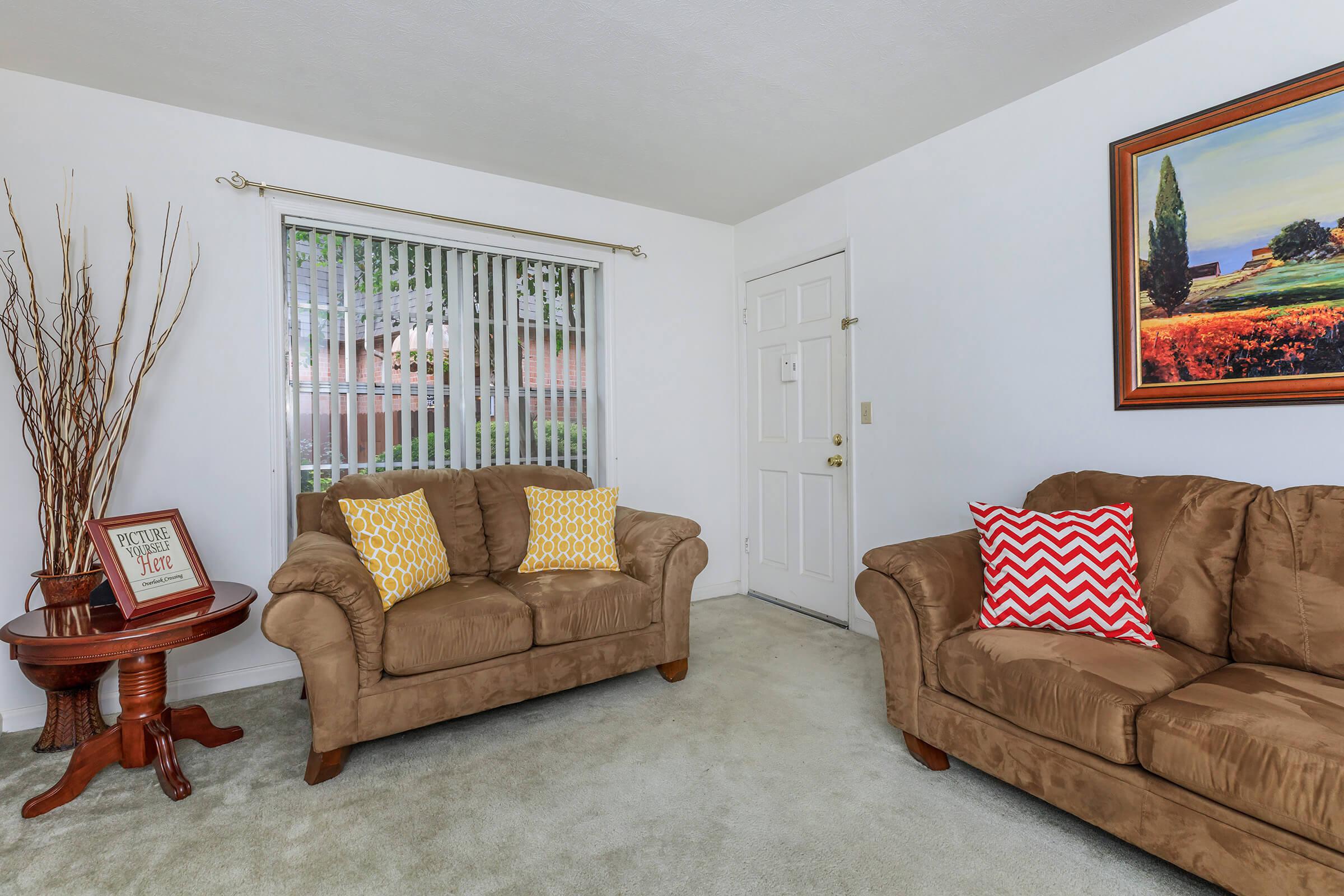 a living room filled with furniture and a flat screen tv