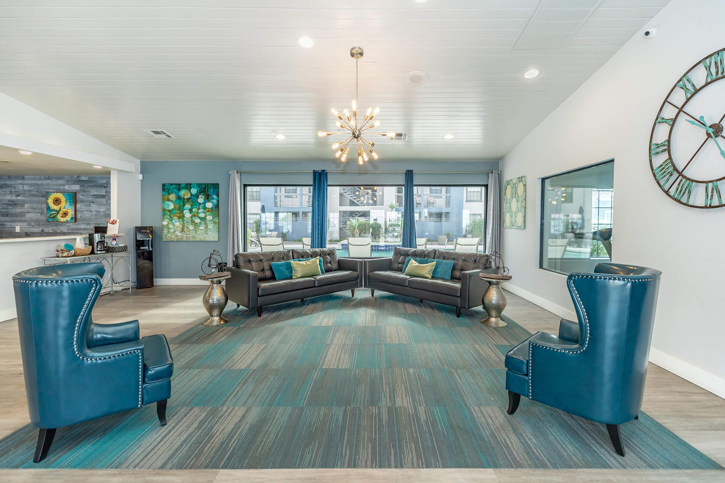 a living room filled with furniture and a blue chair