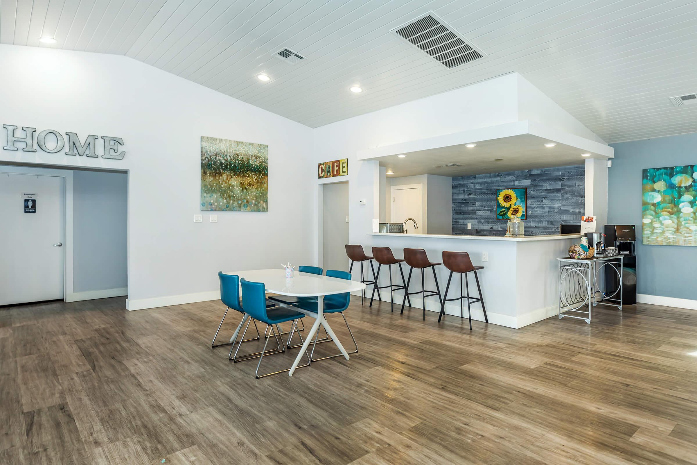 a room filled with furniture on top of a wooden floor